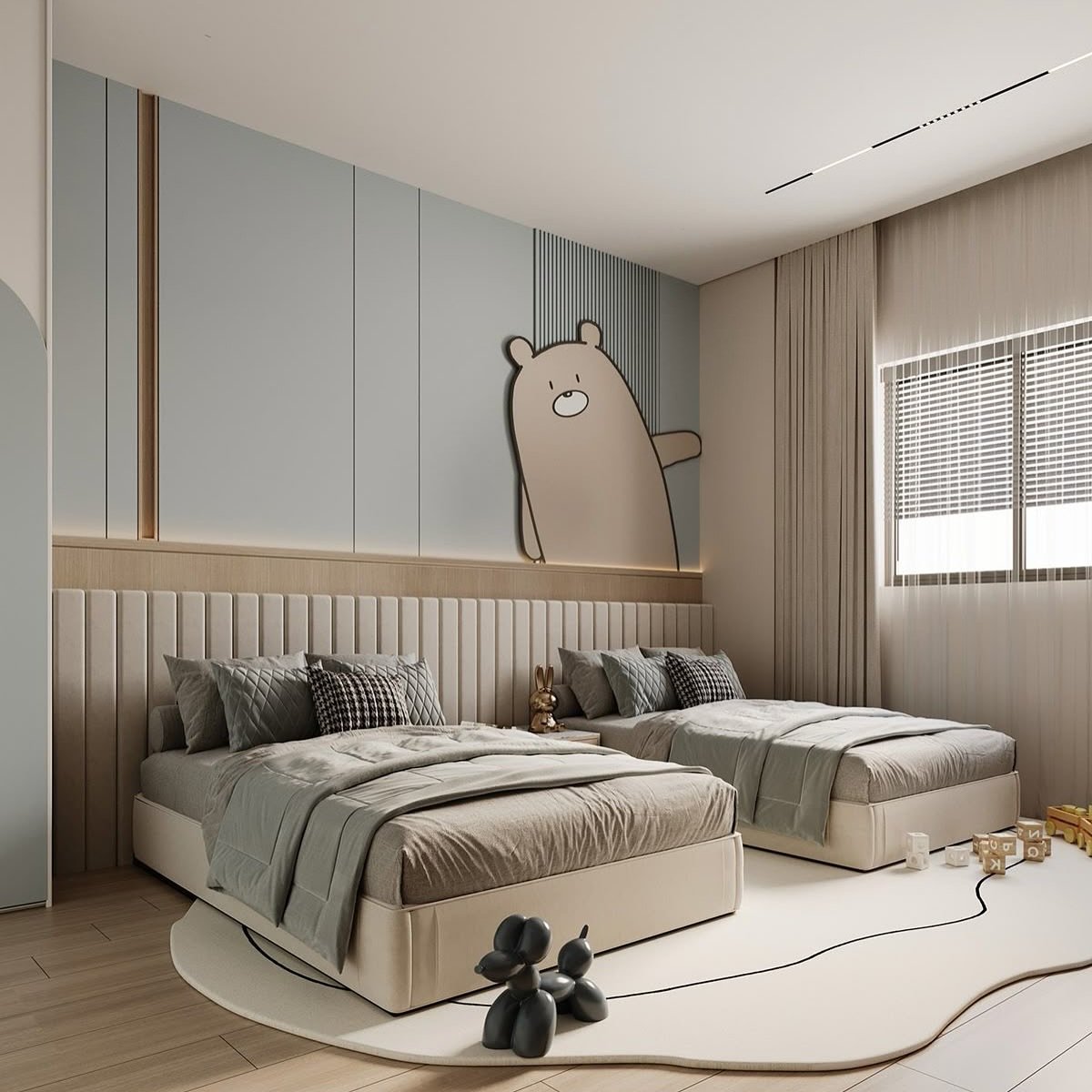 A shared Kid's bedroom with two twin beds side-by-side. The beds are against a feature wall with a large, friendly bear peeking over a headboard that extends across the entire wall. The room is decorated in a soft blue, beige, and gray palette.