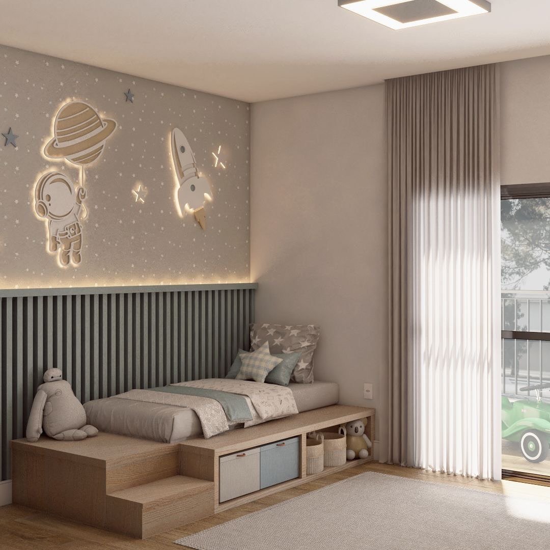 A child's bedroom with a single bed on a light wood platform with built-in storage and steps. The accent wall is decorated with a subtle star pattern and features glowing neon-style wall art of an astronaut and a rocket ship. A large, plush Baymax toy sits on the steps.