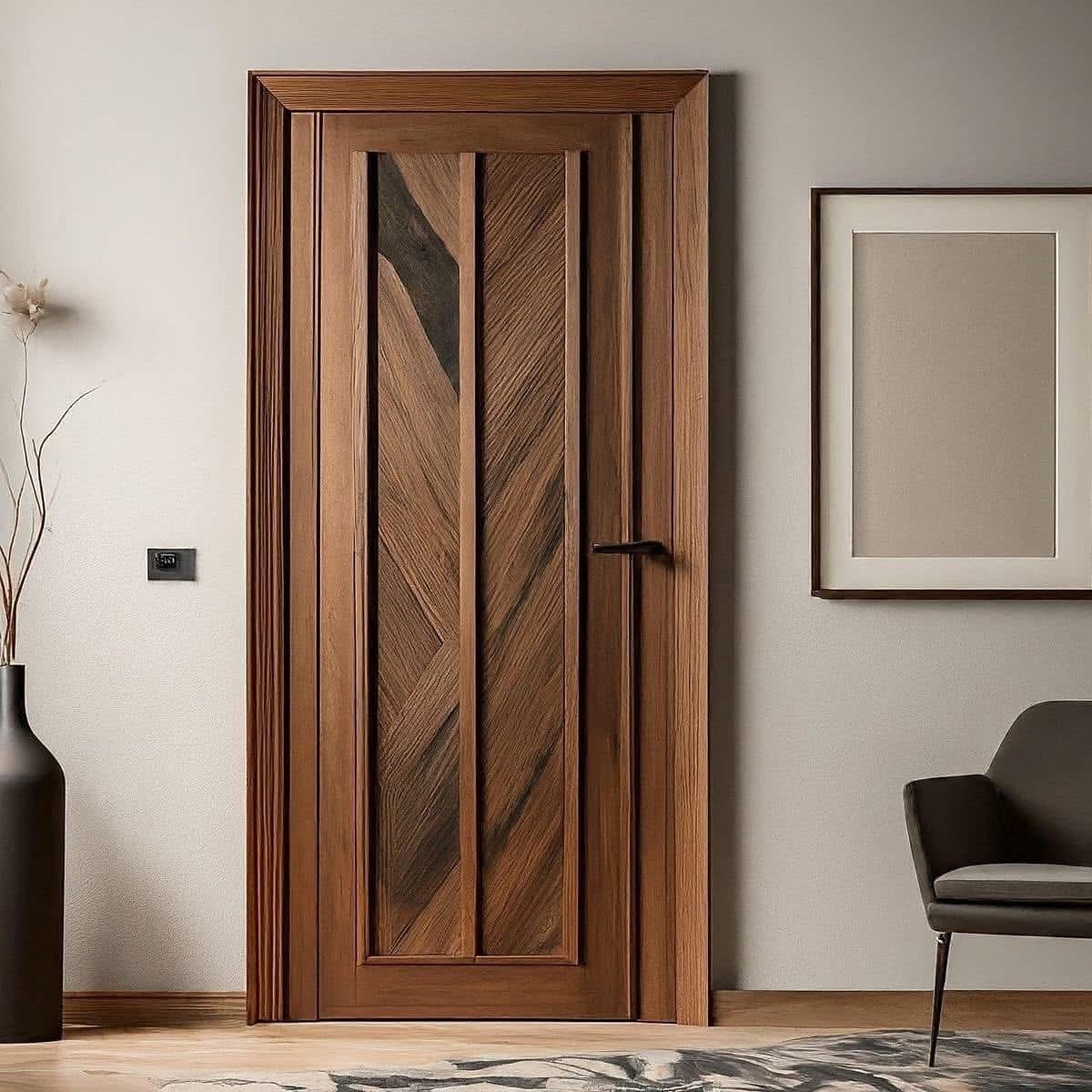 A close-up of a modern wooden bedroom door with a chevron pattern and a dark, sleek handle, framed by simple wood casing.