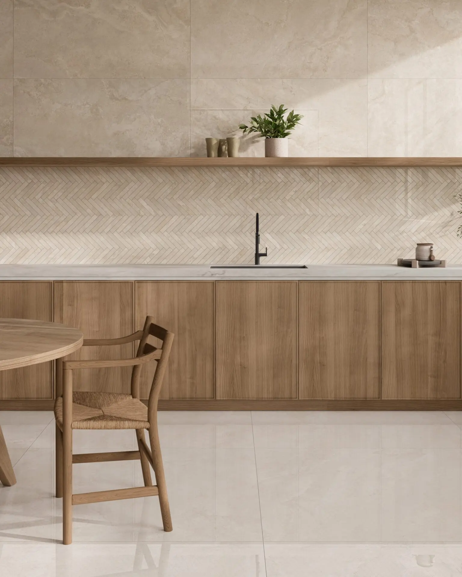 A minimalist kitchen featuring a backsplash with small, light beige herringbone tiles, complemented by a light wood cabinet and countertop.