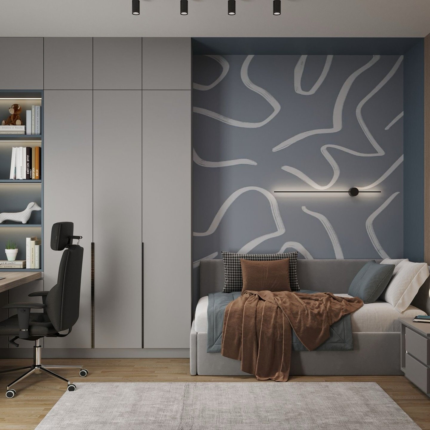 A modern teenage boy's bedroom with a gray daybed, a large mural-like abstract wall design, and a built-in closet and desk unit.