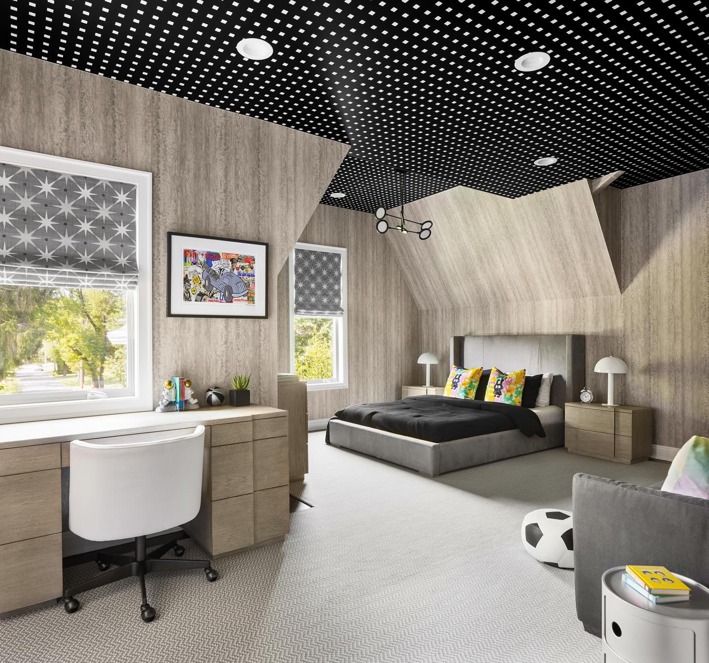 A teenage boy's bedroom with light wood plank walls, a gray bed, a built-in desk, and a striking black and white patterned ceiling.