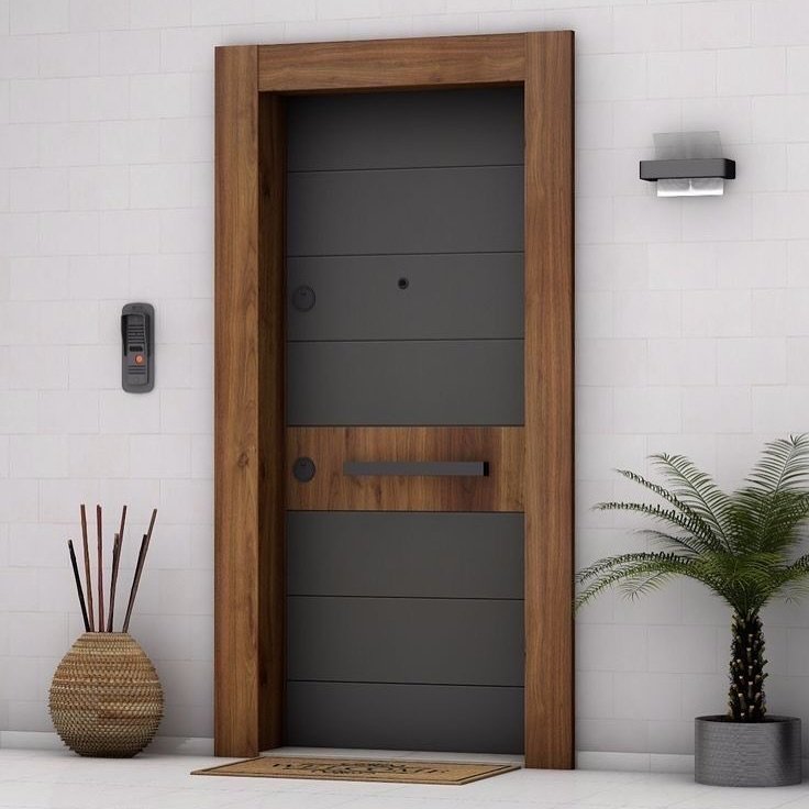 A modern exterior door with a dark gray, horizontally grooved panel surrounded by a thick, natural wood frame, featuring a long horizontal handle.