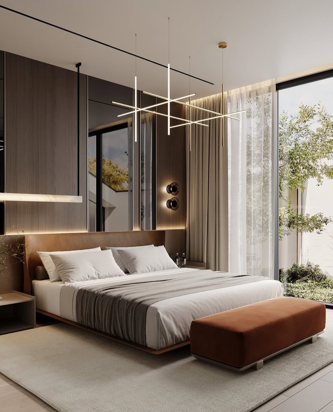 A modern master bedroom with a warm brown and white color scheme, a low-profile bed with a leather headboard, and a unique linear chandelier.