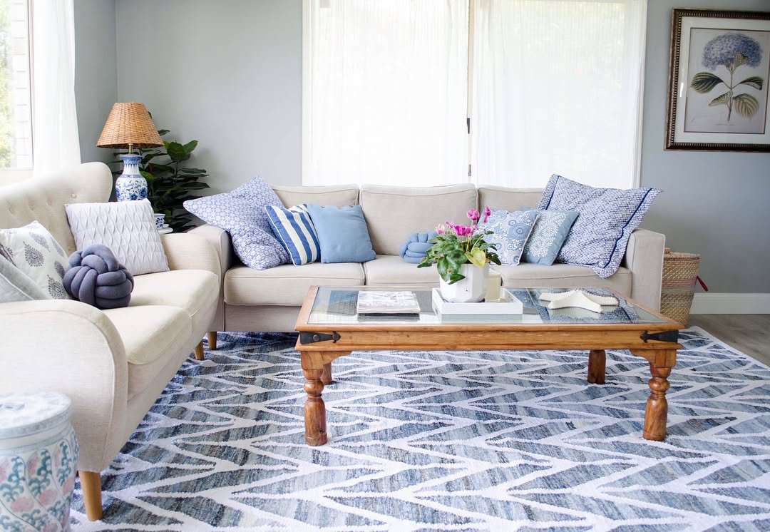 A modern area rug with a bold blue and white zigzag pattern on a light wood floor.