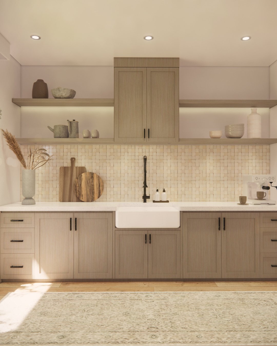 A kitchen featuring a backsplash of small, textured square mosaic tiles in a natural, light tone, complementing light wood cabinets and open shelving.
