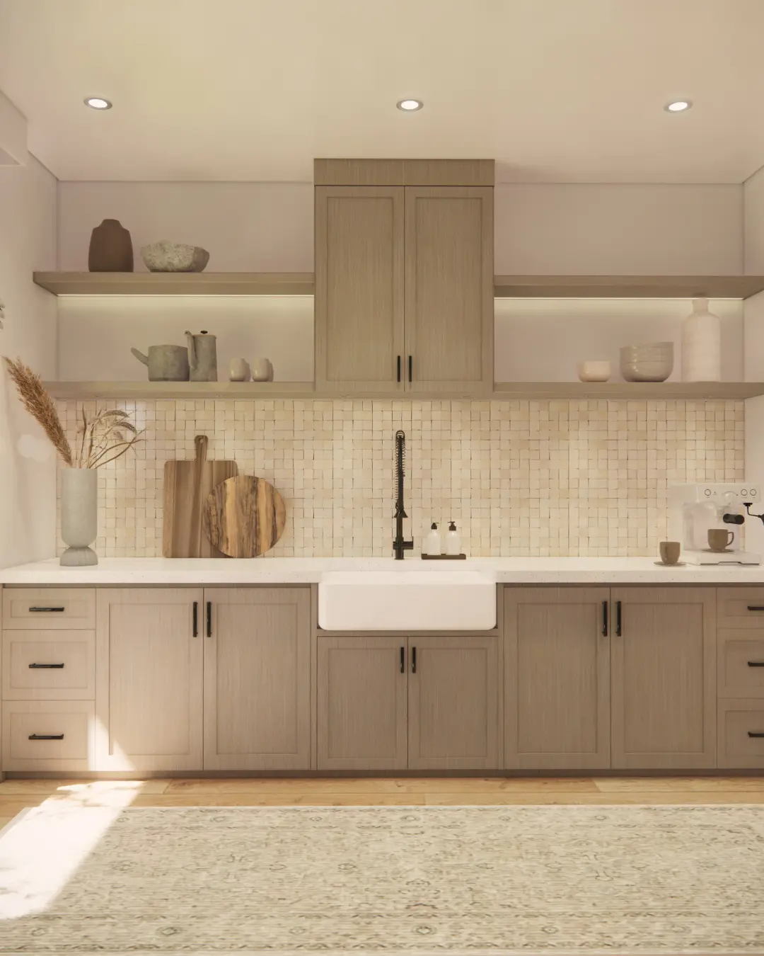 A kitchen featuring a backsplash of small, textured square mosaic tiles in a natural, light tone, complementing light wood cabinets and open shelving.