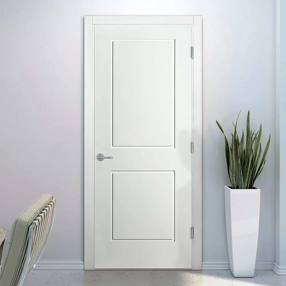 A pristine white bedroom door with a two-panel Shaker style design and a sleek chrome lever handle, set in a minimalist white room.