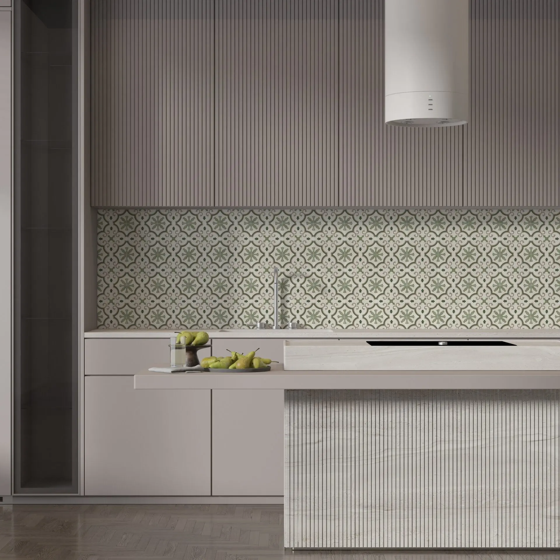 A contemporary kitchen with a backsplash of vintage-inspired patterned tiles in sage green and off-white, contrasted with smooth and fluted gray cabinetry.