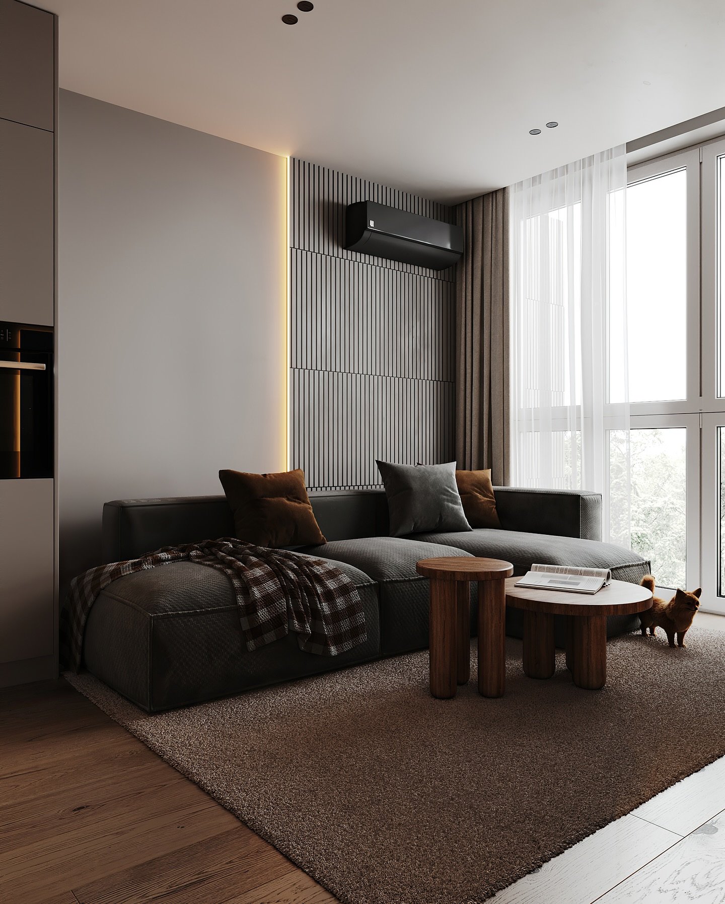 A cozy, modern living space featuring a dark gray sectional sofa, a slatted wood accent wall, and simple wooden coffee tables.
