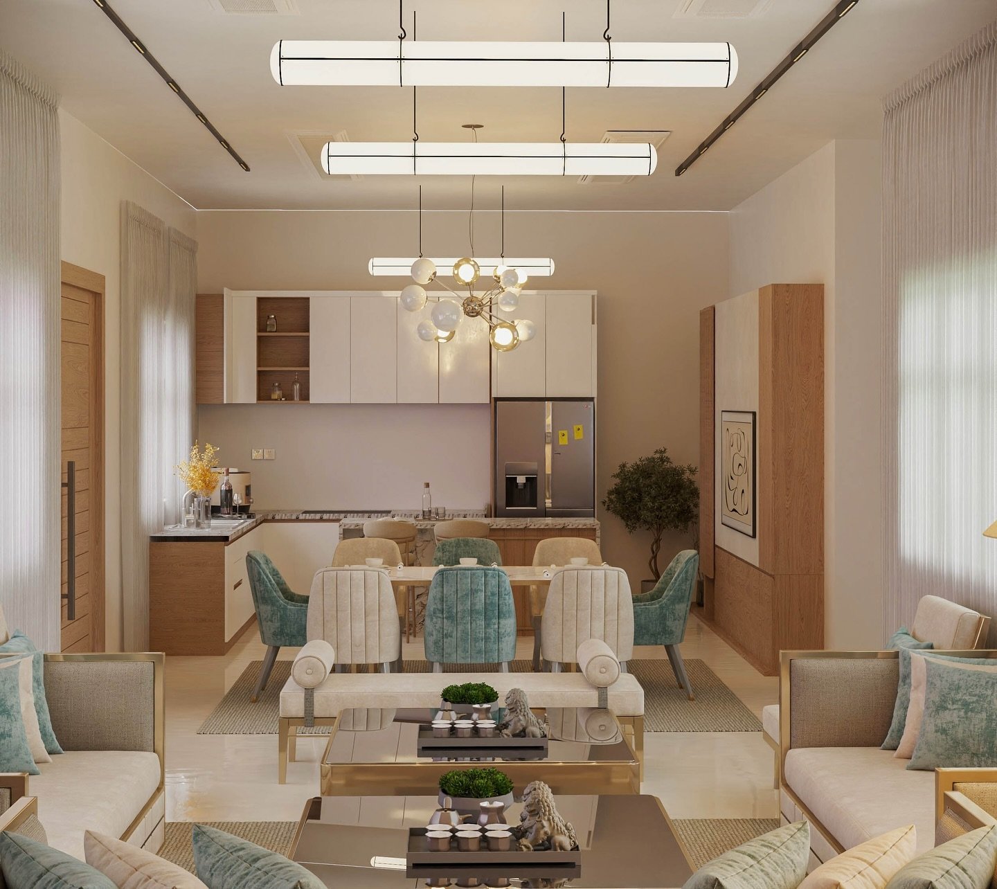 A luxurious and modern open-concept living and dining area. The living room features twin sofas and a glass-topped coffee table. The dining area has a long wooden table with plush velvet chairs in a mix of cream and teal colors. A compact kitchen with white and wood cabinets is visible behind the dining table.