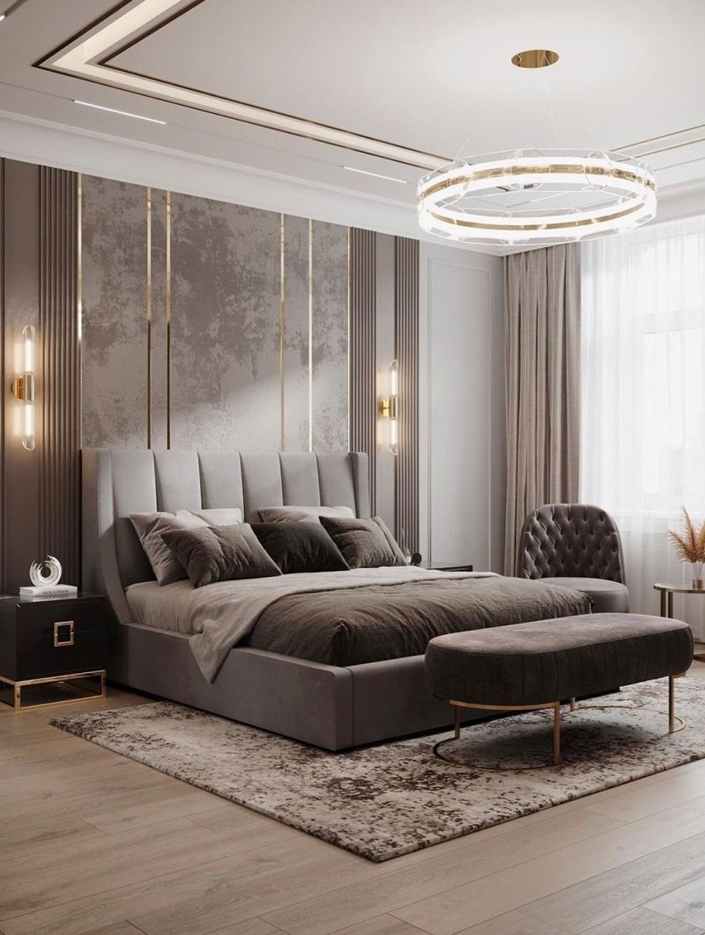 A dark, abstract-patterned rug is placed under a gray bed and a matching bench in a modern bedroom with a wood floor.