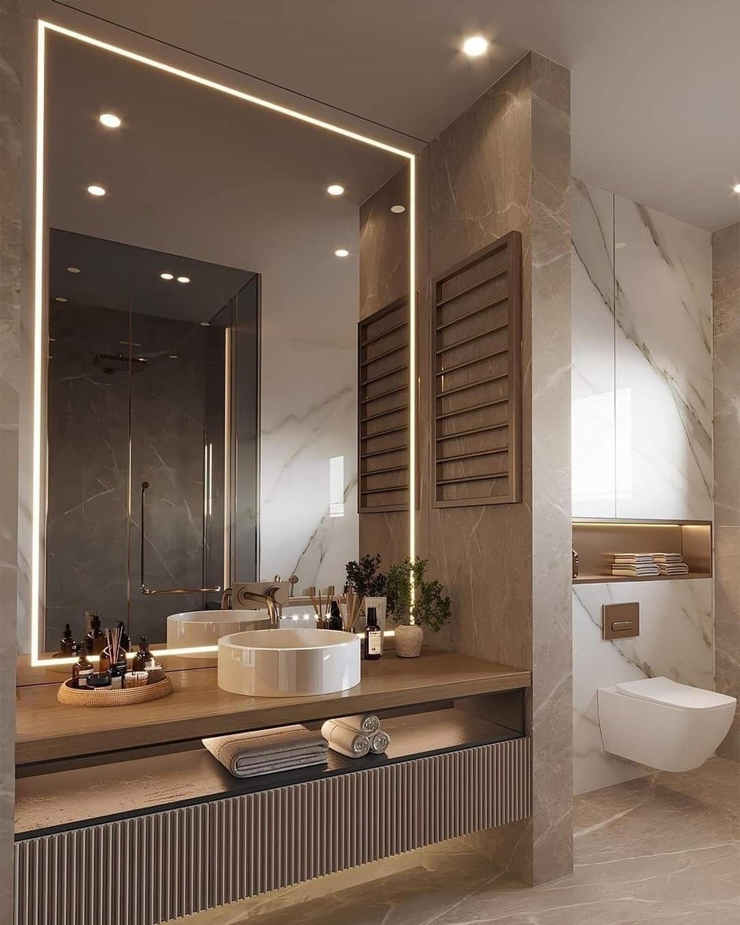 A contemporary small bathroom featuring a large rectangular mirror with a glowing LED frame, a vessel sink on a wooden countertop, and marble-look tiles.