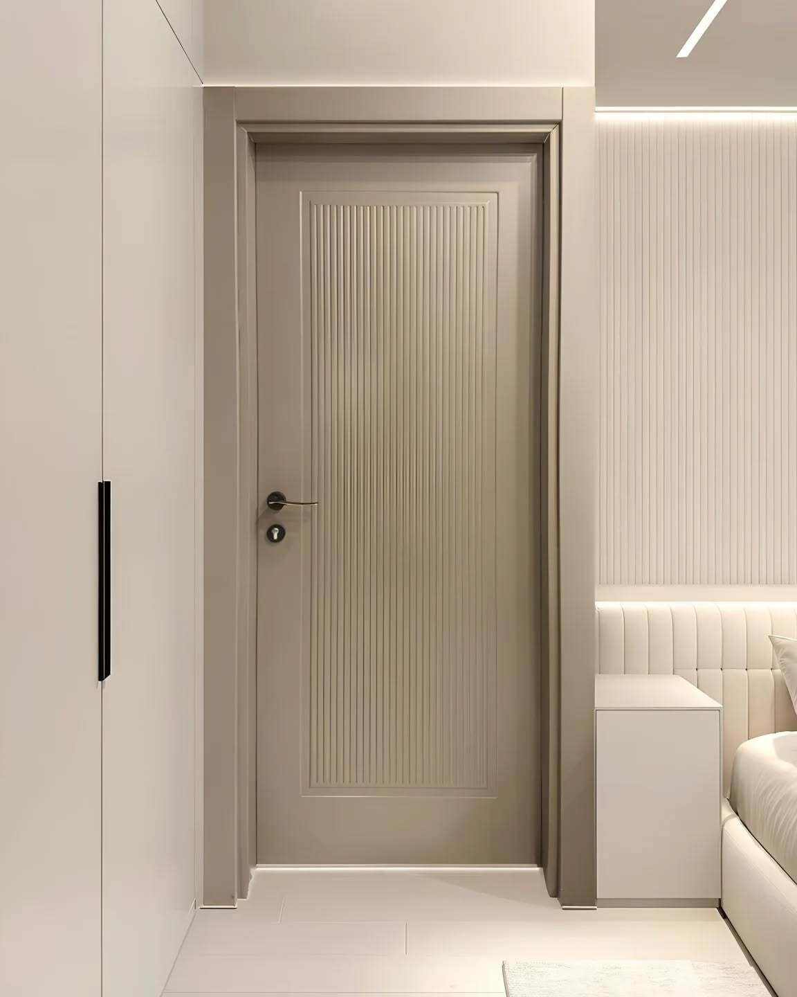 A contemporary bedroom door in a light taupe color, featuring vertical grooves in a central rectangular panel, with simple matte black hardware.