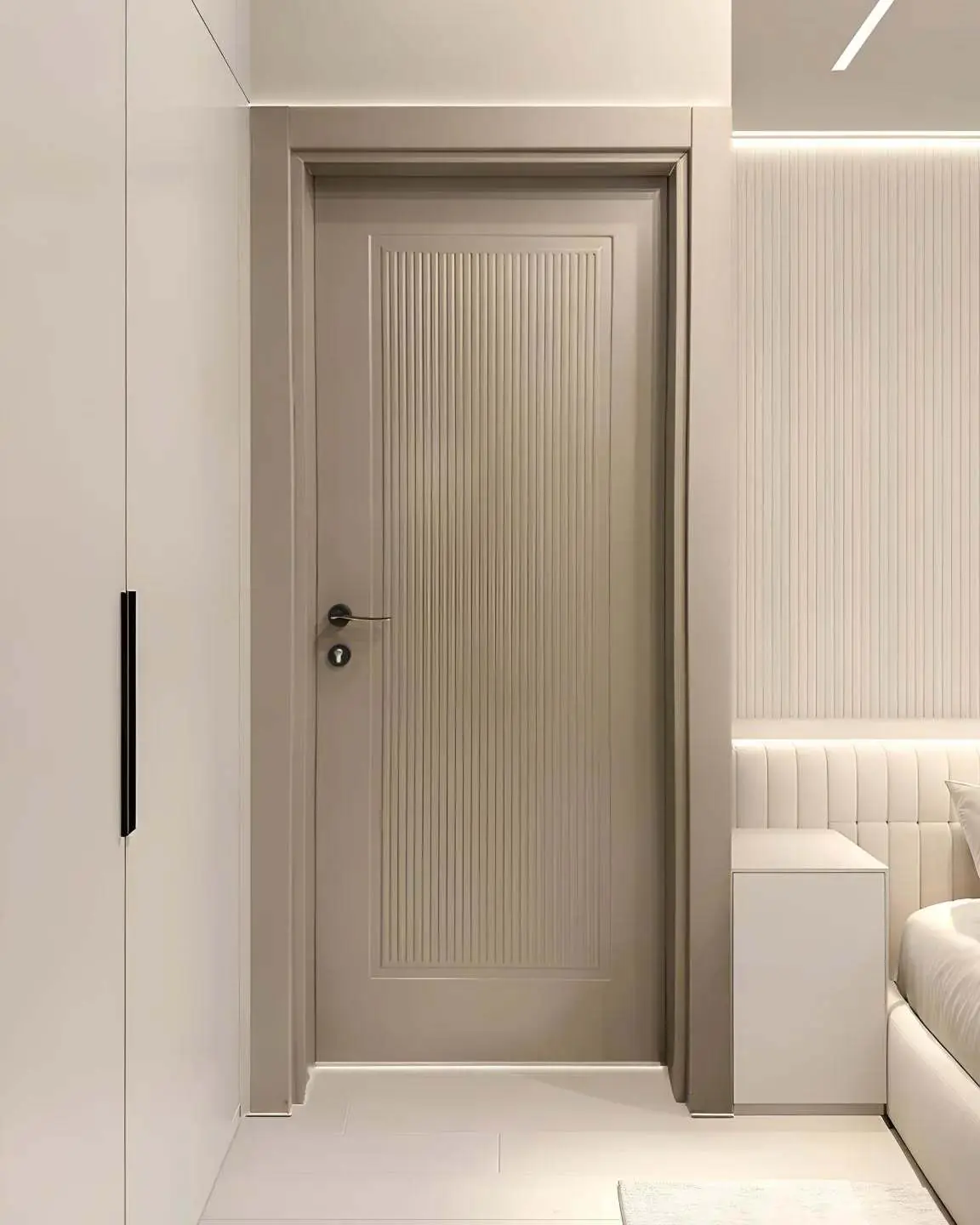 A contemporary bedroom door in a light taupe color, featuring vertical grooves in a central rectangular panel, with simple matte black hardware.