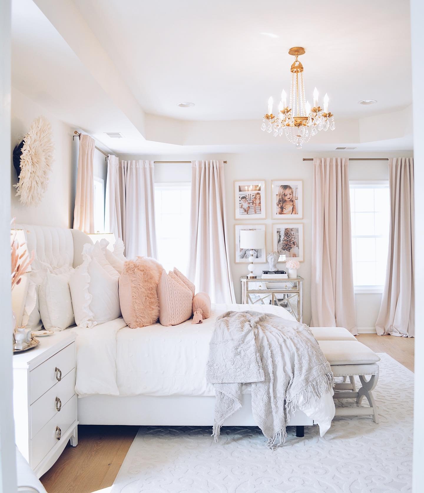 A glamorous bedroom with a white and blush pink color scheme.