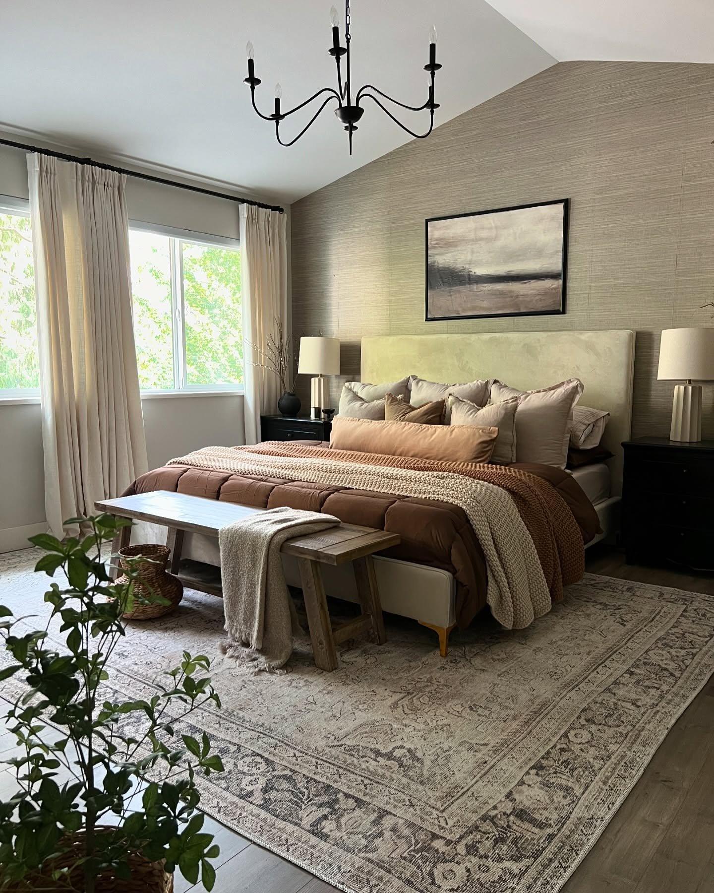 A bedroom with a slanted ceiling and textured walls, featuring a bed with a brown and beige color scheme.