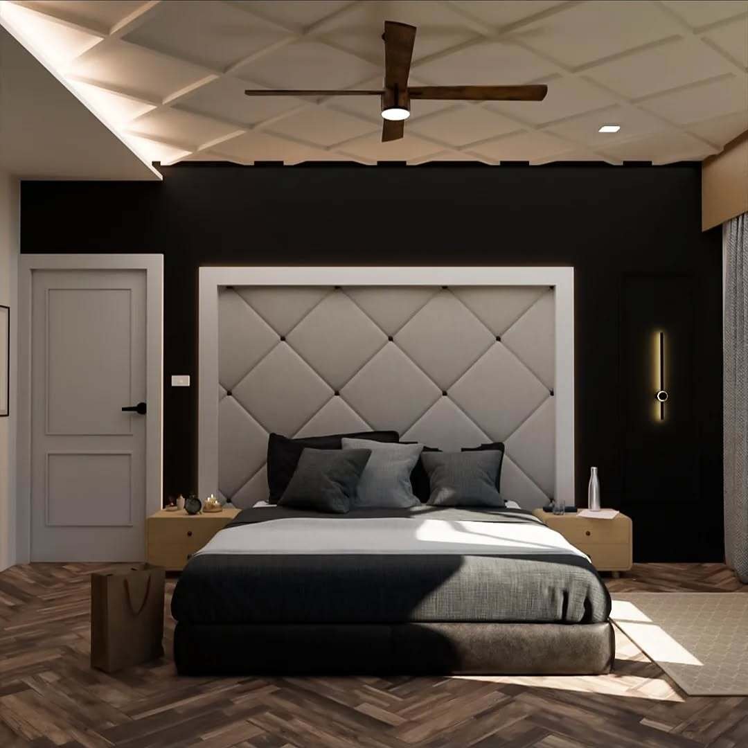 A modern bedroom with a black accent wall, a large diamond-quilted headboard, light wood nightstands, and a geometric-patterned coffered ceiling.