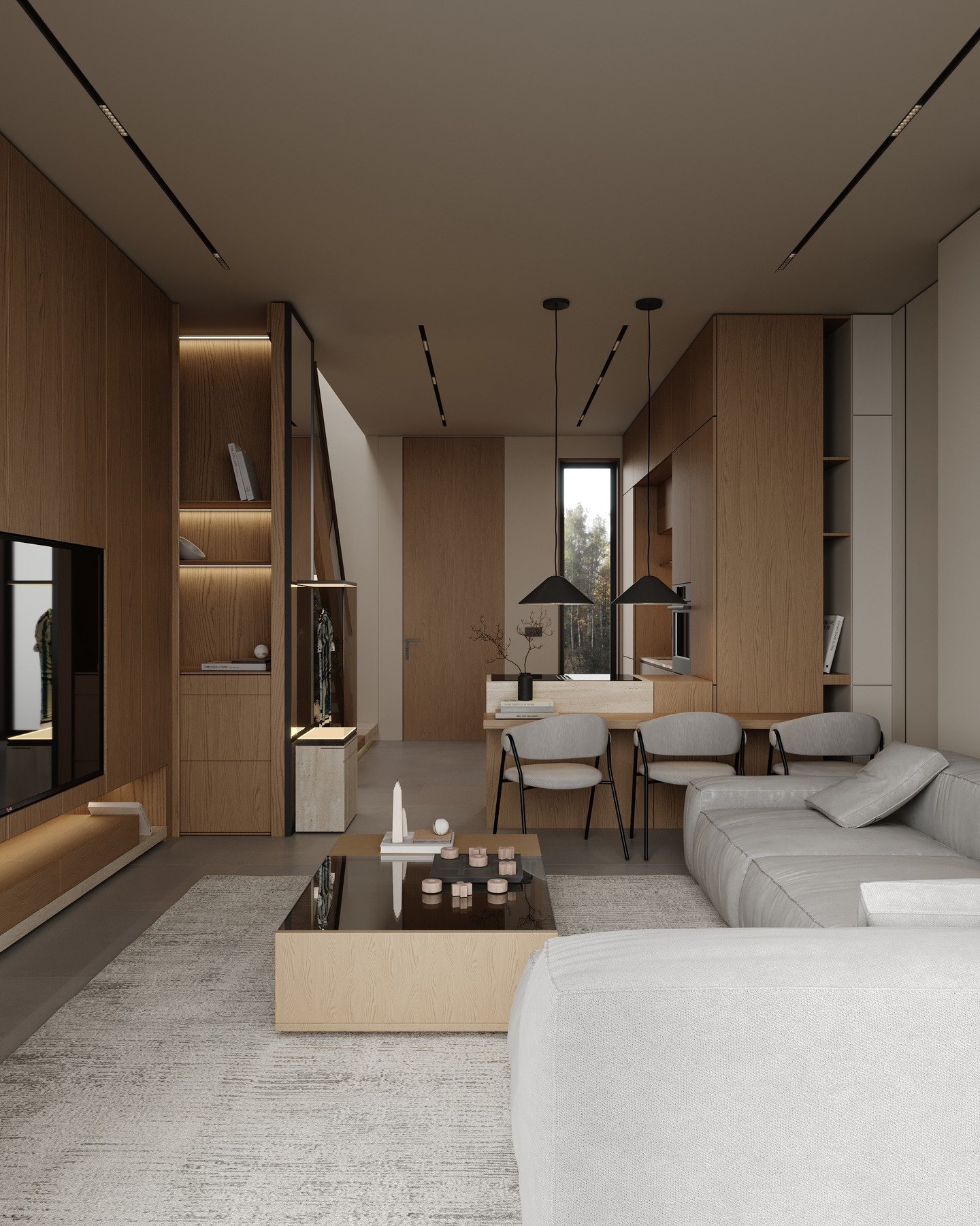 A modern, open-plan living and dining area with light wood paneling, a gray sectional sofa, a black-framed coffee table, and minimalist linear lighting.