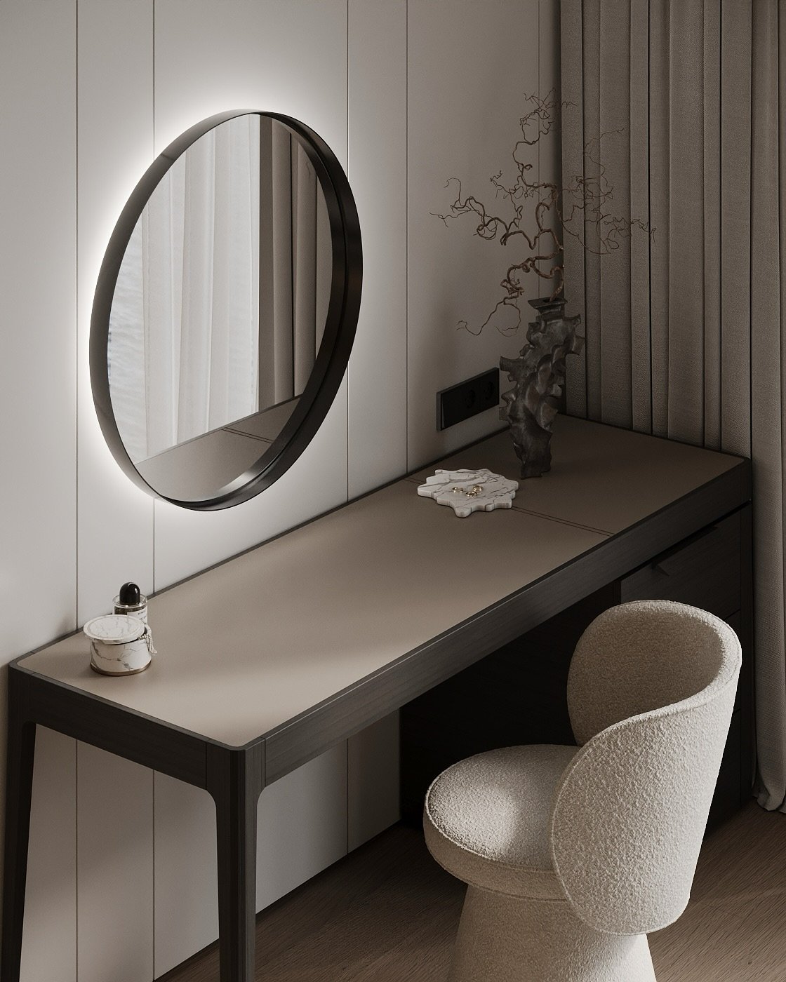 A sleek, modern bedroom vanity with a round, backlit mirror hanging above a dark wood and gray leather desk, and a textured white chair.