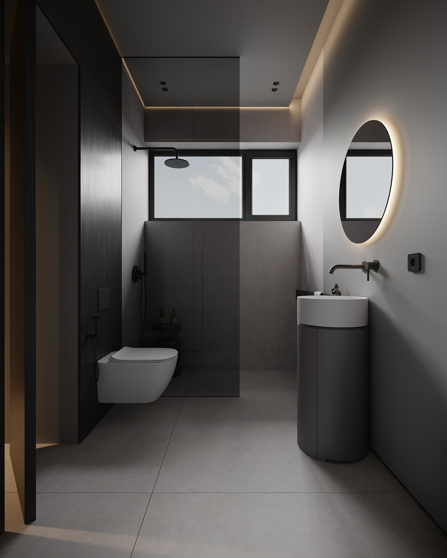 A narrow, modern bathroom with grey concrete walls, a cylindrical grey vanity, a floating toilet, and a backlit oval mirror.