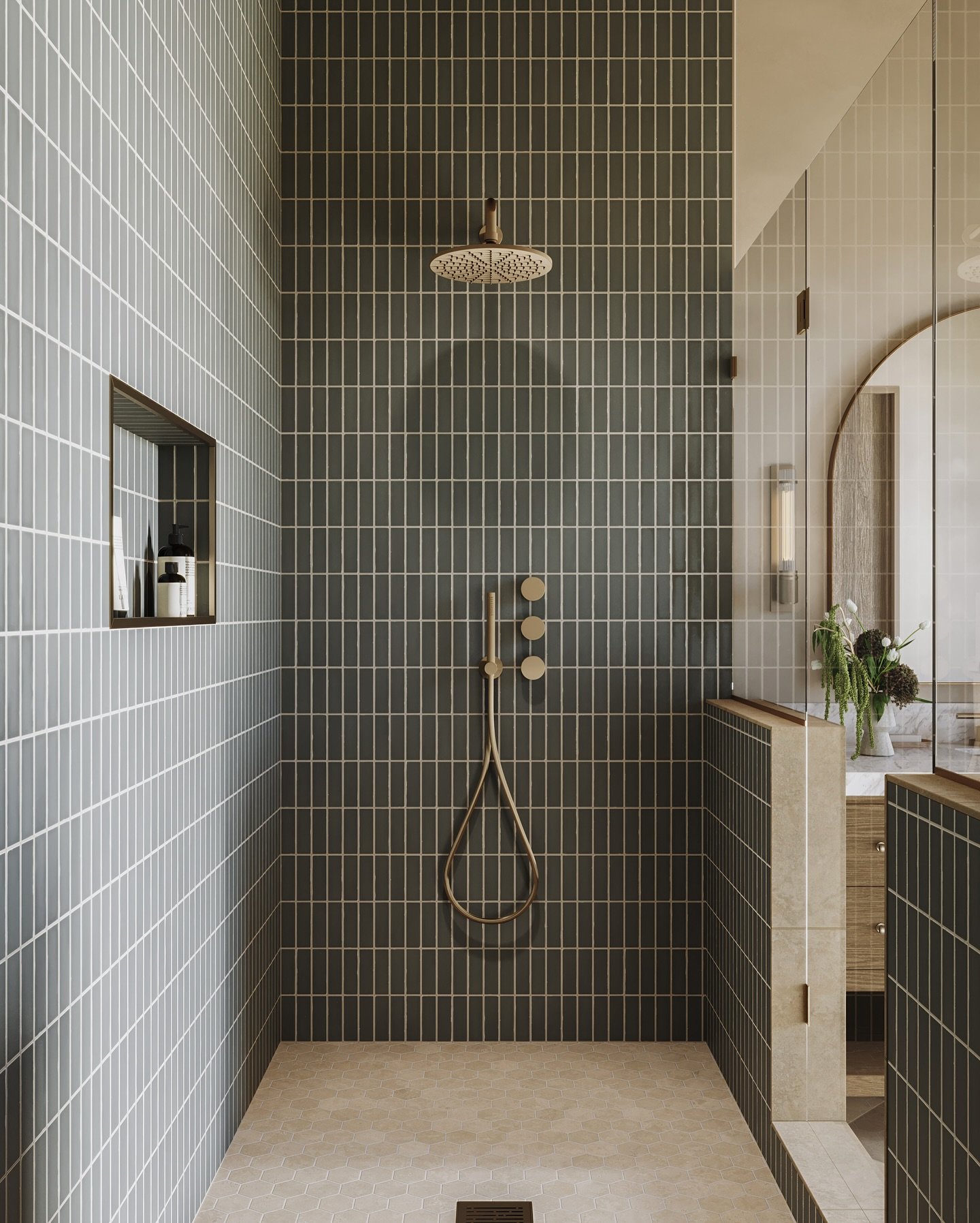 A sleek, modern bathroom with a single-color scheme of olive green square tiles on the walls and ceiling, a white freestanding bathtub, and a marble bench.