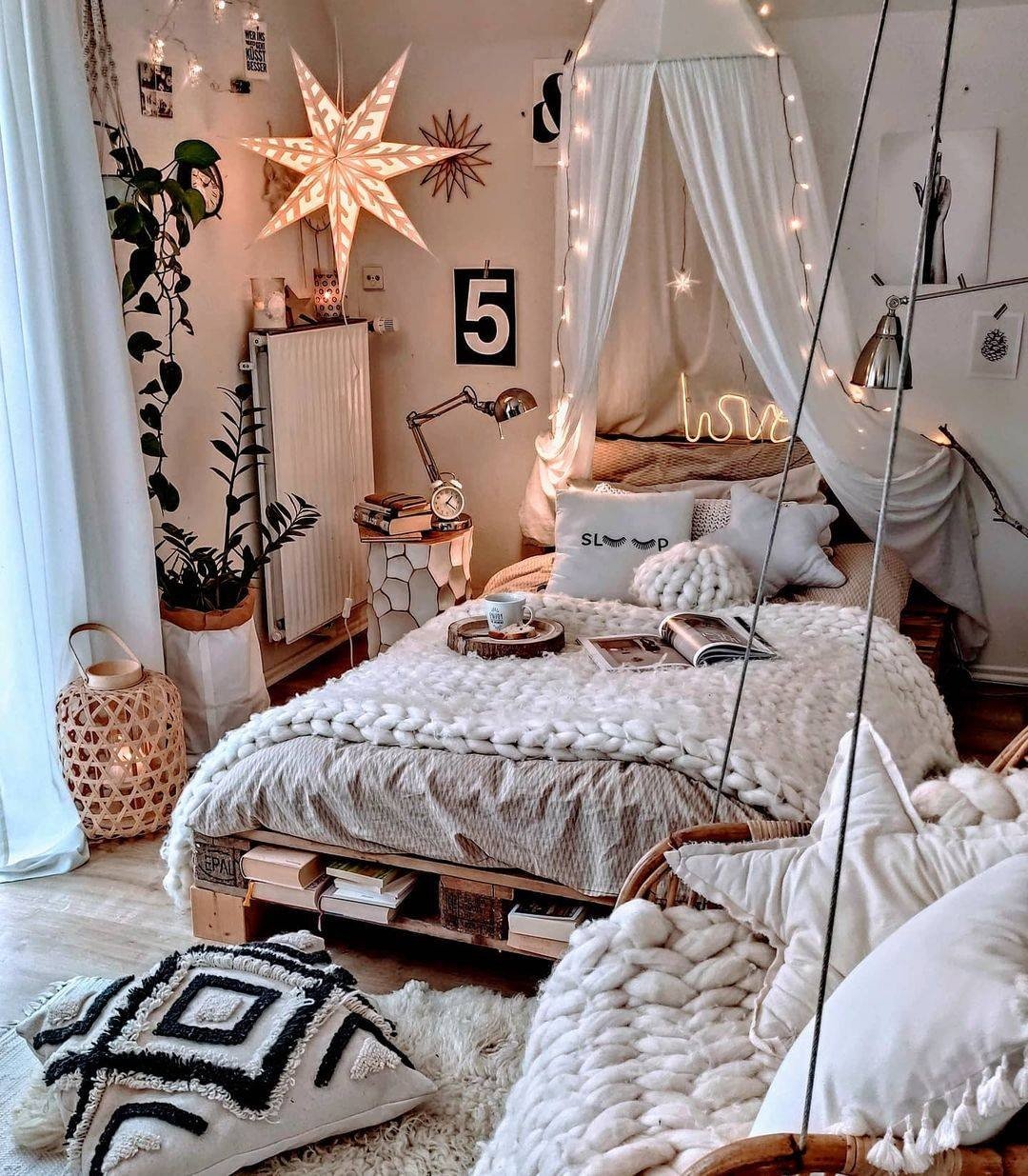 A cozy, whimsical boho bedroom with a canopy bed, a hanging egg chair, and warm fairy lights.