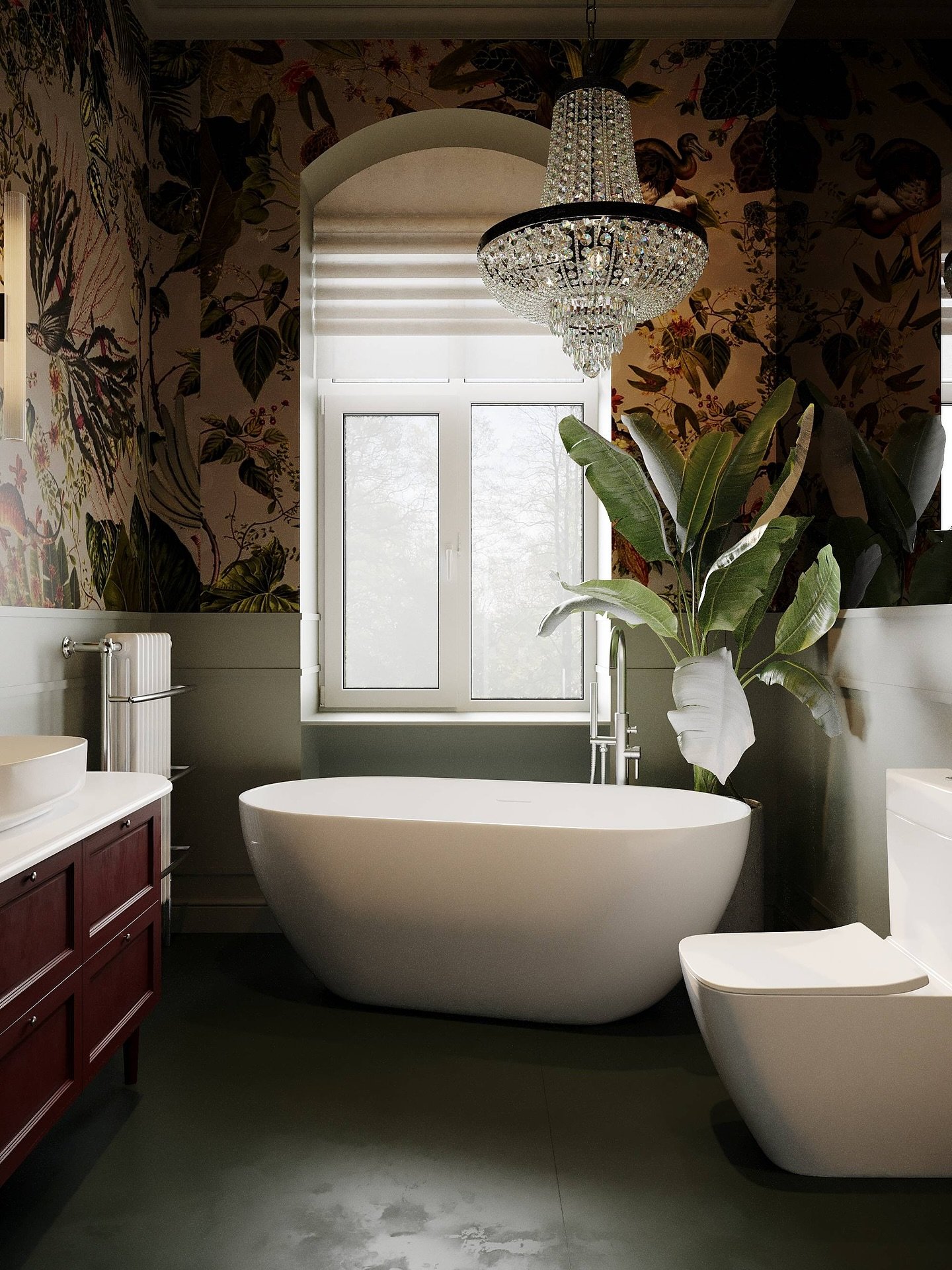 An eclectic bathroom with a dramatic nature-themed wallpaper, a crystal chandelier, a freestanding tub, and a red wood vanity.