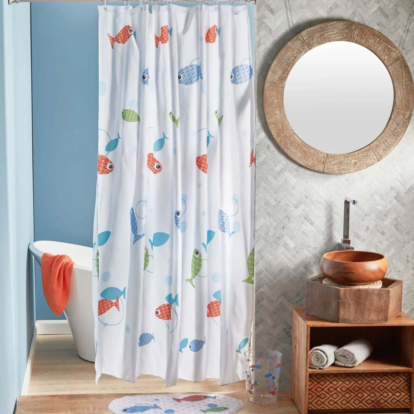 A white shower curtain with a scattered, repeat pattern of small, cartoon-style fish in bright coral, blue, and lime green.