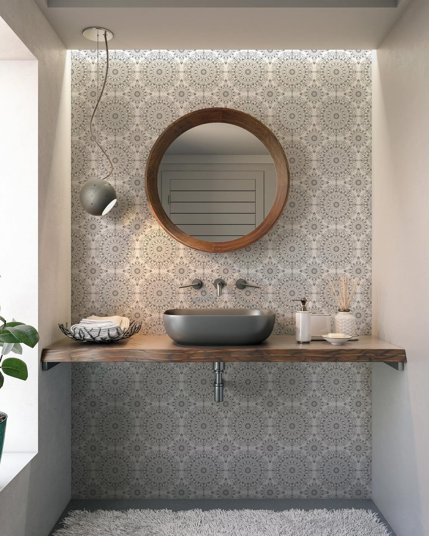 A small bathroom sink nook with a gray vessel sink on a live-edge wooden countertop.