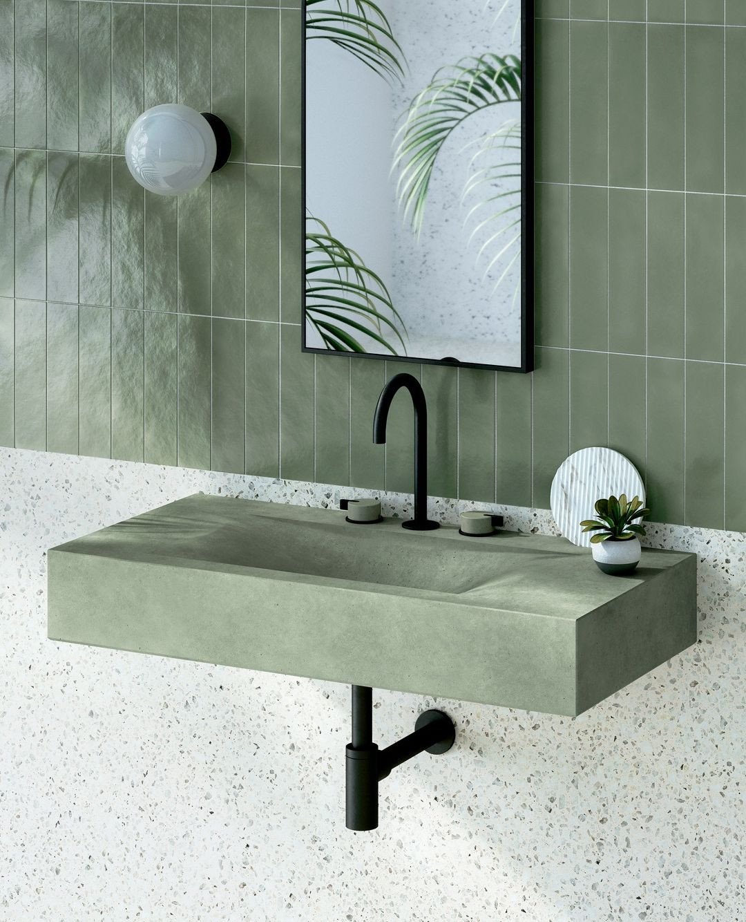 A contemporary bathroom with a floating, sage green concrete sink.
