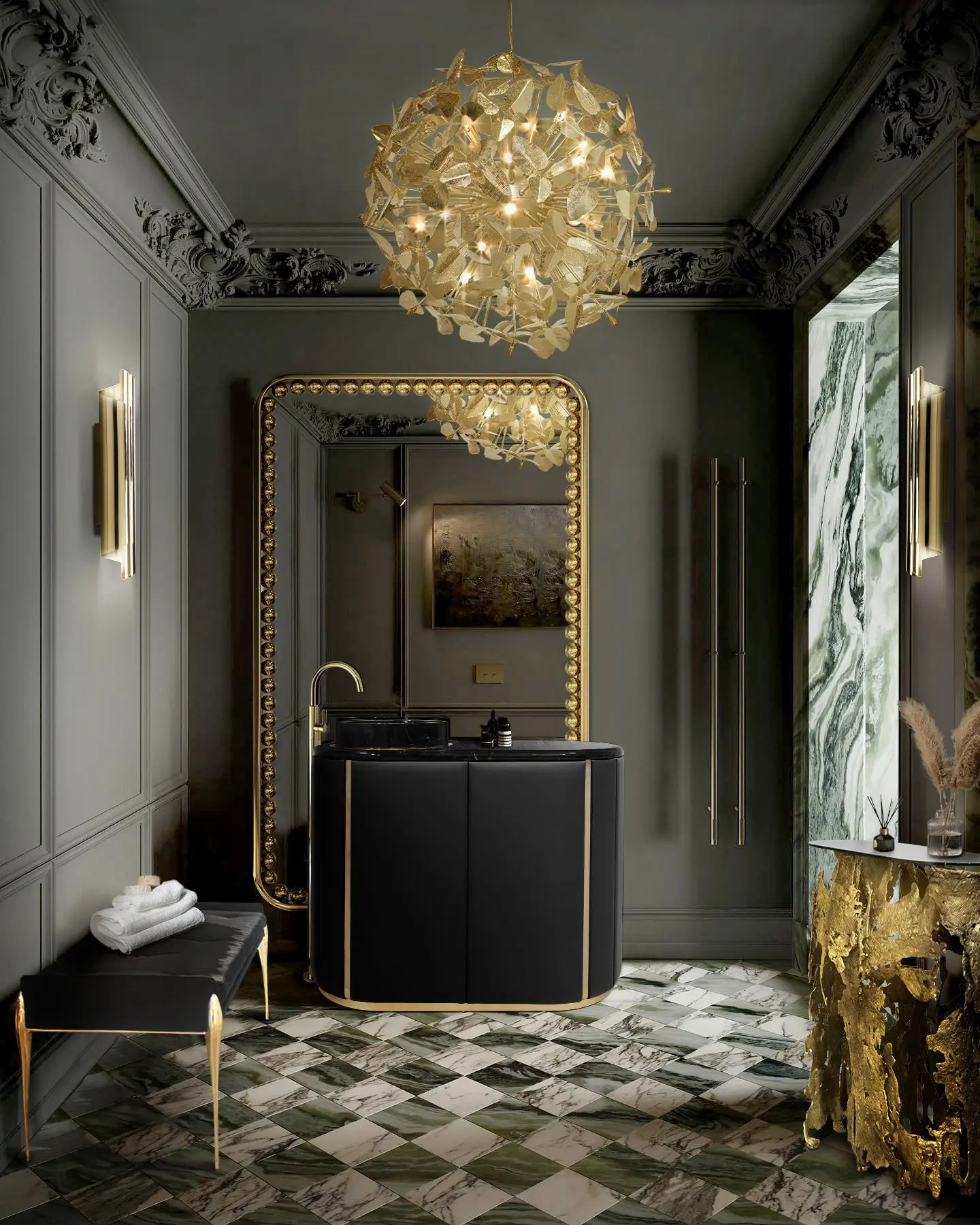 A luxurious bathroom with a large, ornate rectangular gold mirror with a textured frame, reflecting a black vanity and a golden chandelier.