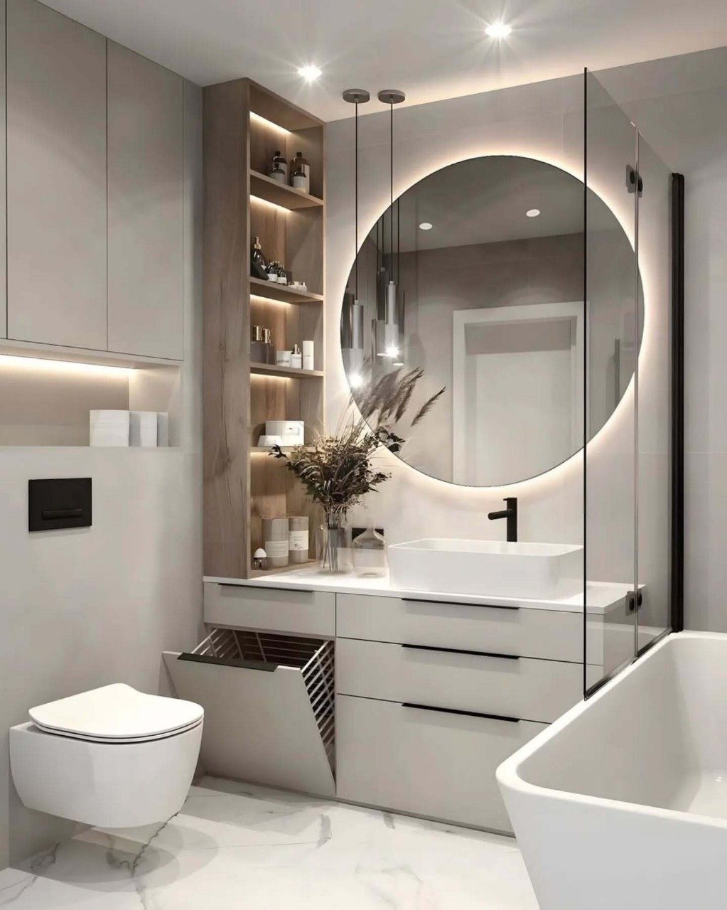 Modern, light-toned bathroom featuring a floating vanity, a backlit circular mirror, a built-in vertical storage niche with backlighting, and a tilt-out laundry hamper below the countertop.