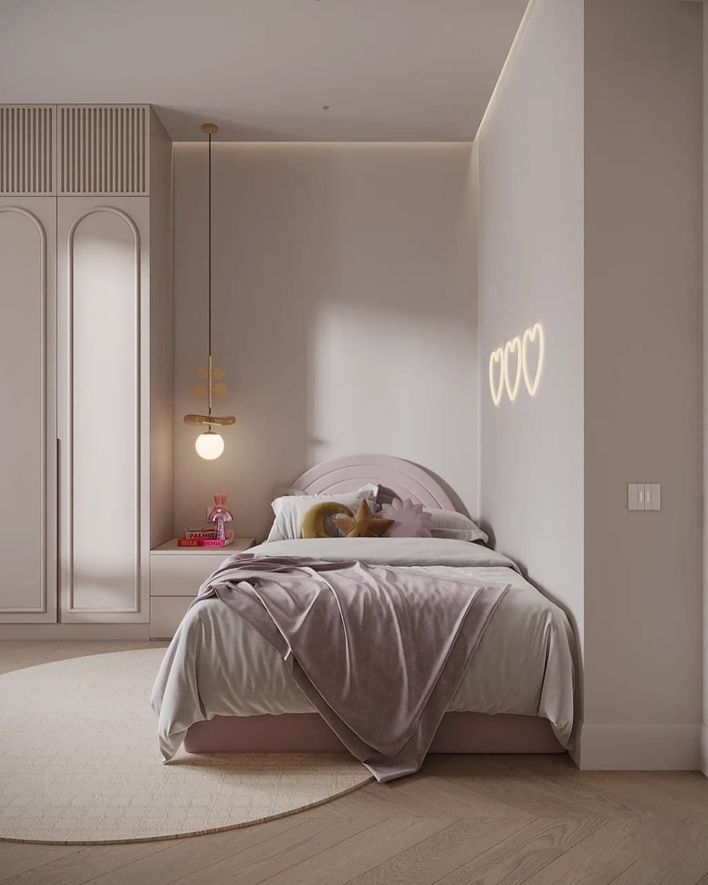 A modern and minimalist bedroom with a bed featuring a light-pink curved headboard, a unique hanging lamp, and a heart-shaped neon light on the wall.