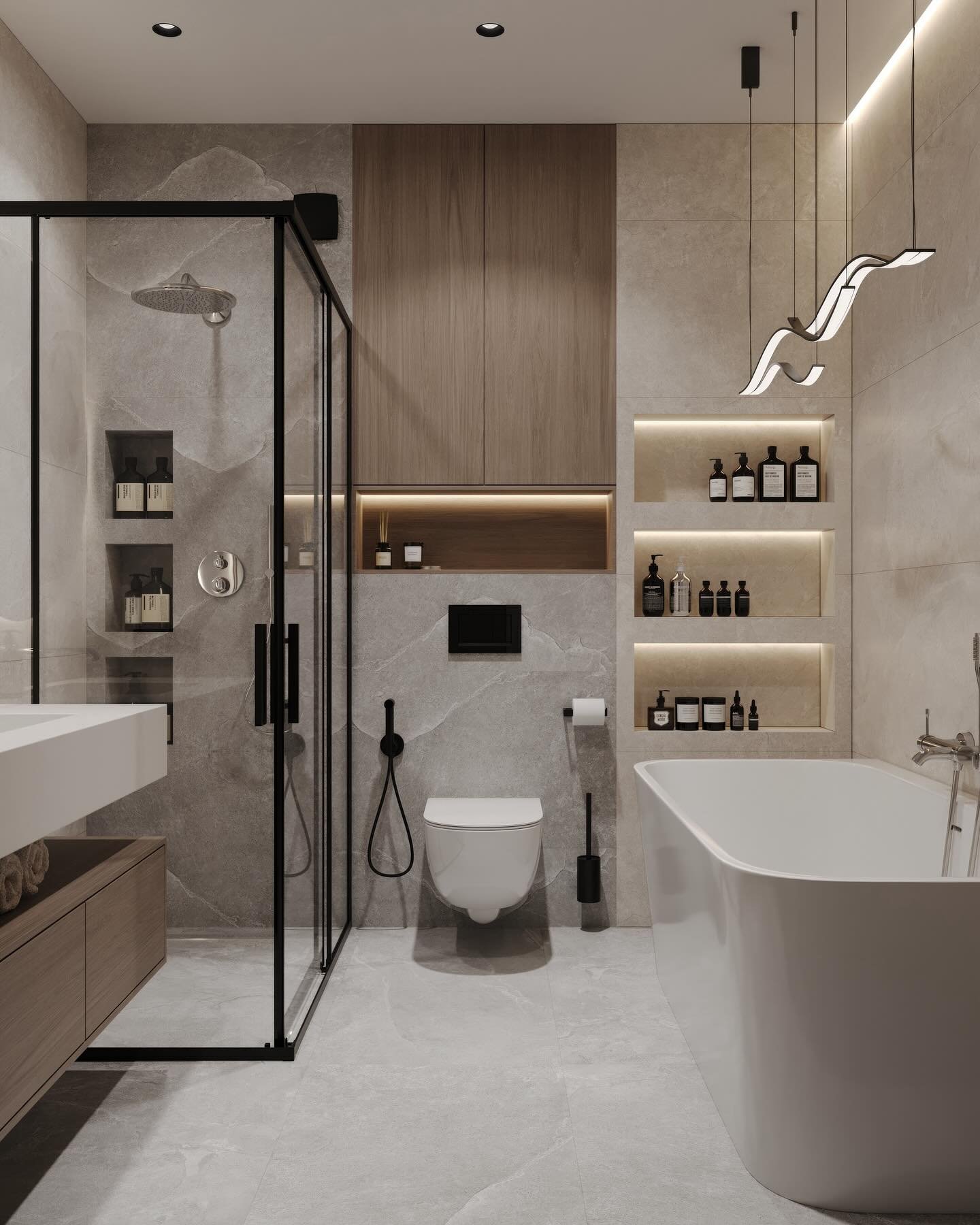 A modern bathroom with grey stone tiles, a black-framed glass shower, a freestanding tub, and light wood cabinetry.