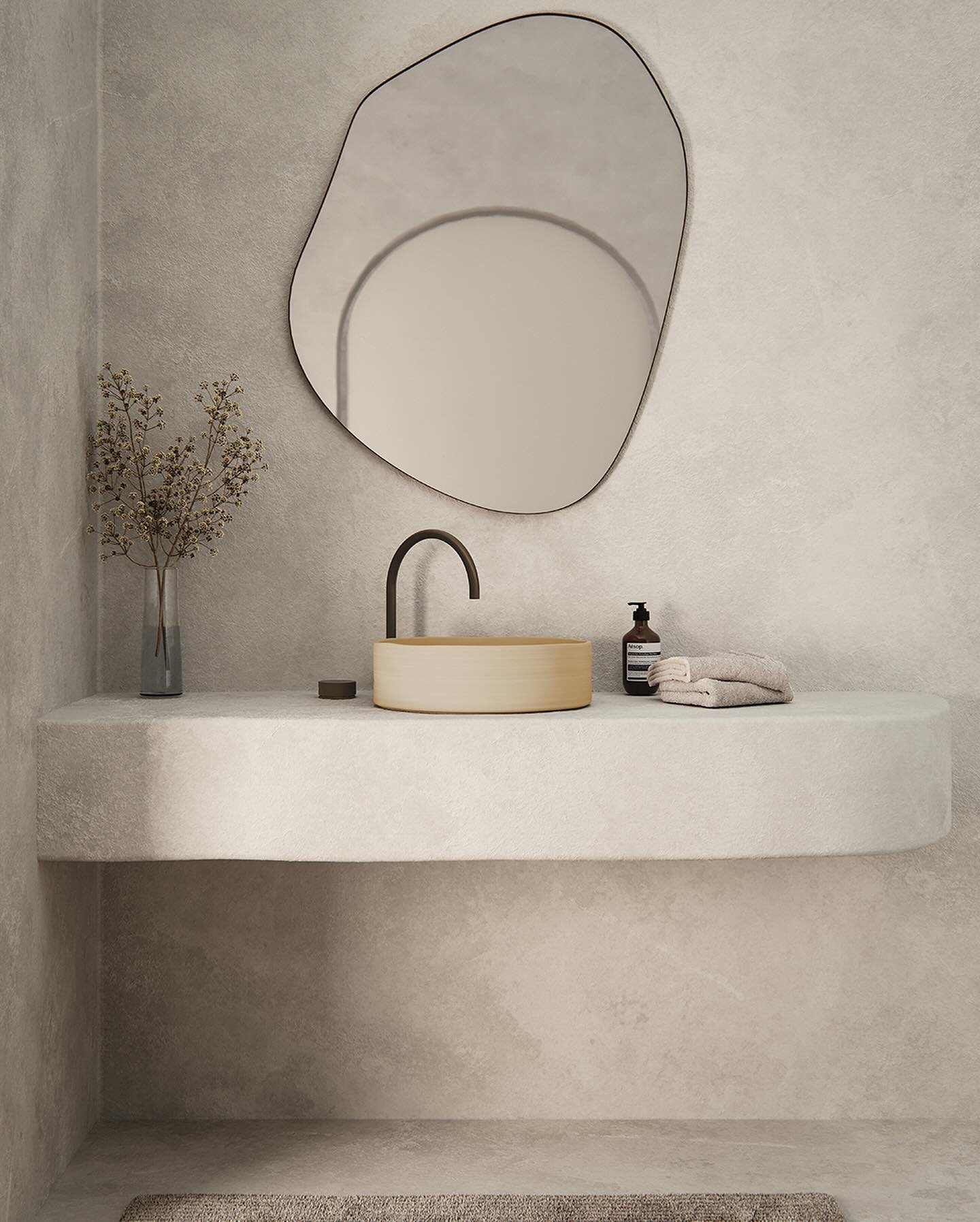 A modern white bathroom with a simple, wall-mounted sink featuring an integrated towel rail. A sleek, wall-mounted black faucet contrasts with the white basin, all set against a textured, light-colored wall.