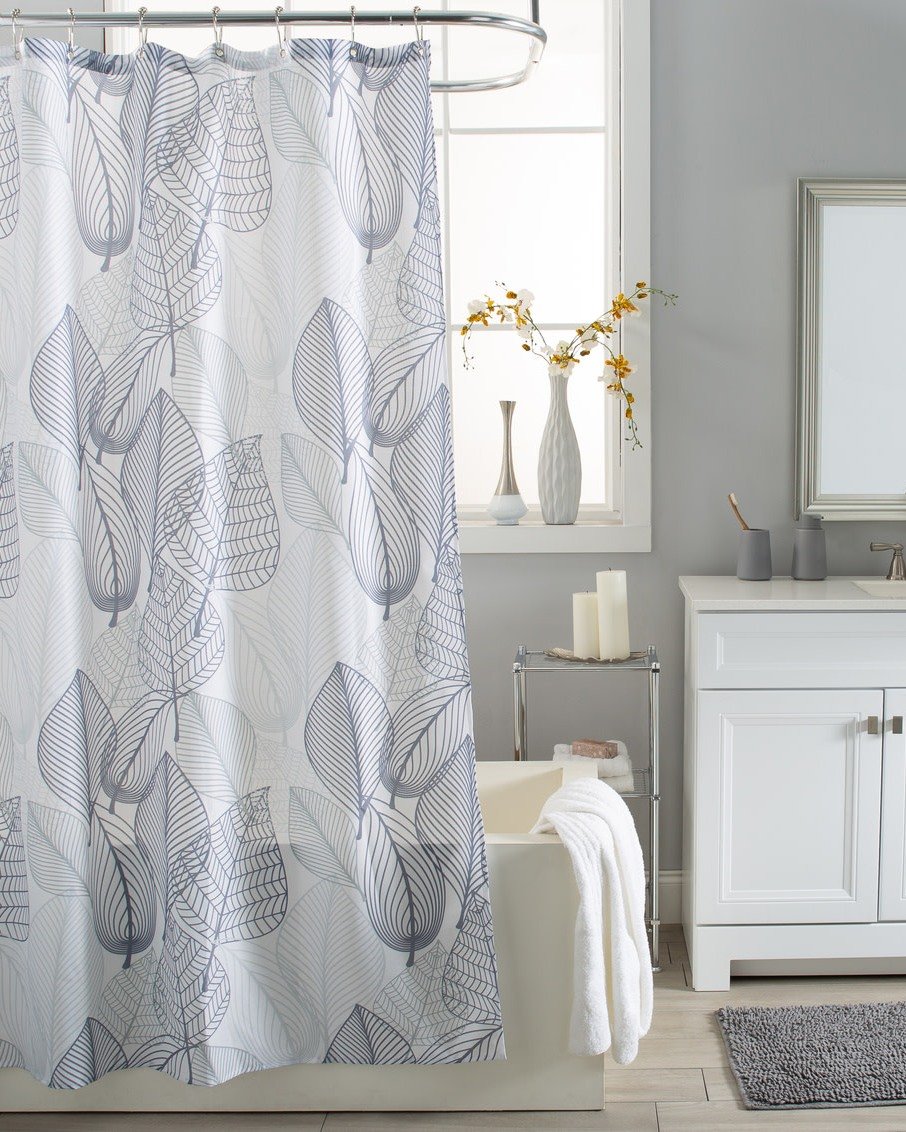 A white shower curtain printed with large, overlapping linear drawings of leaves in various shades of dusty blue and gray.