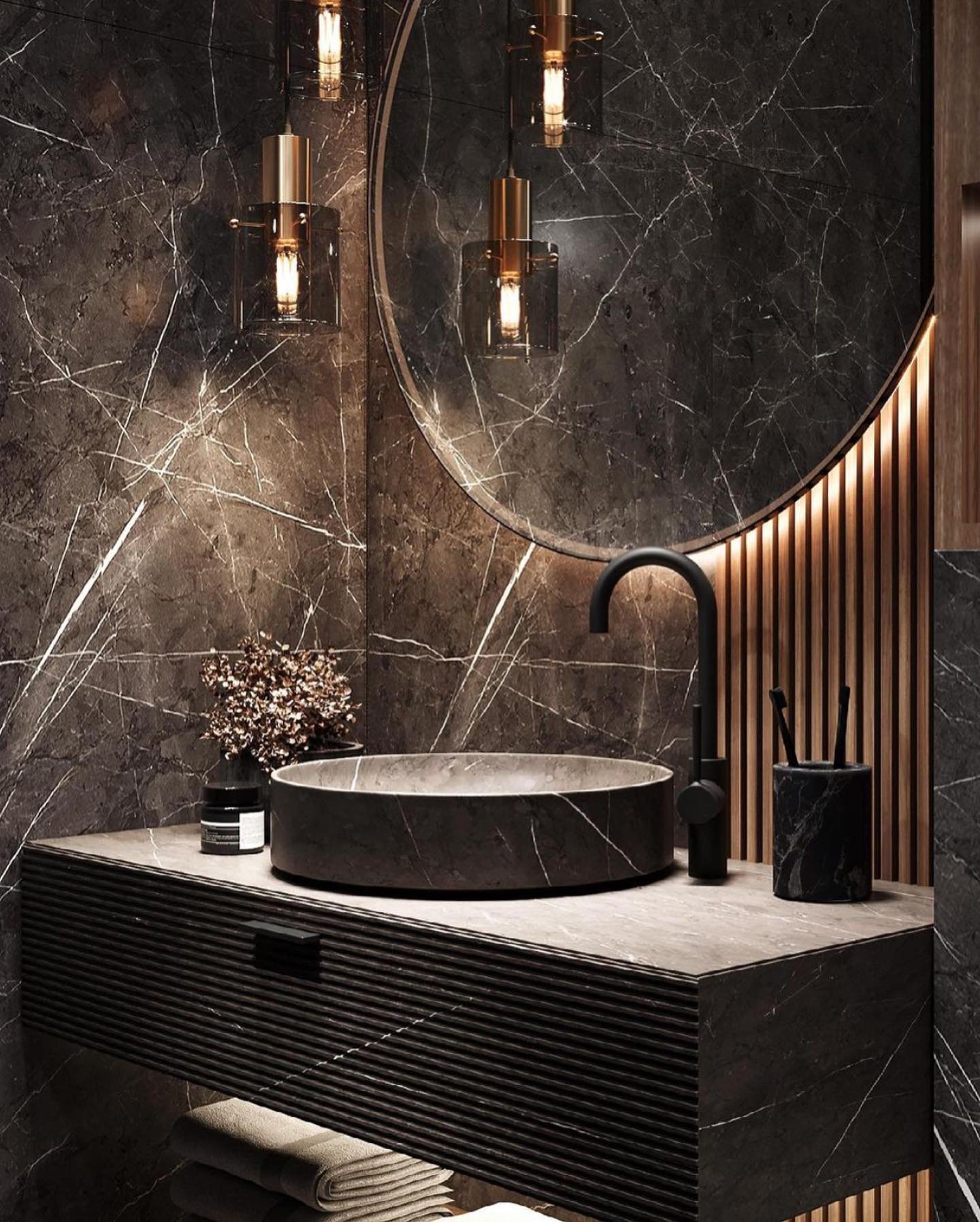 A contemporary bathroom with a dark, textured stone vessel sink on a floating vanity.