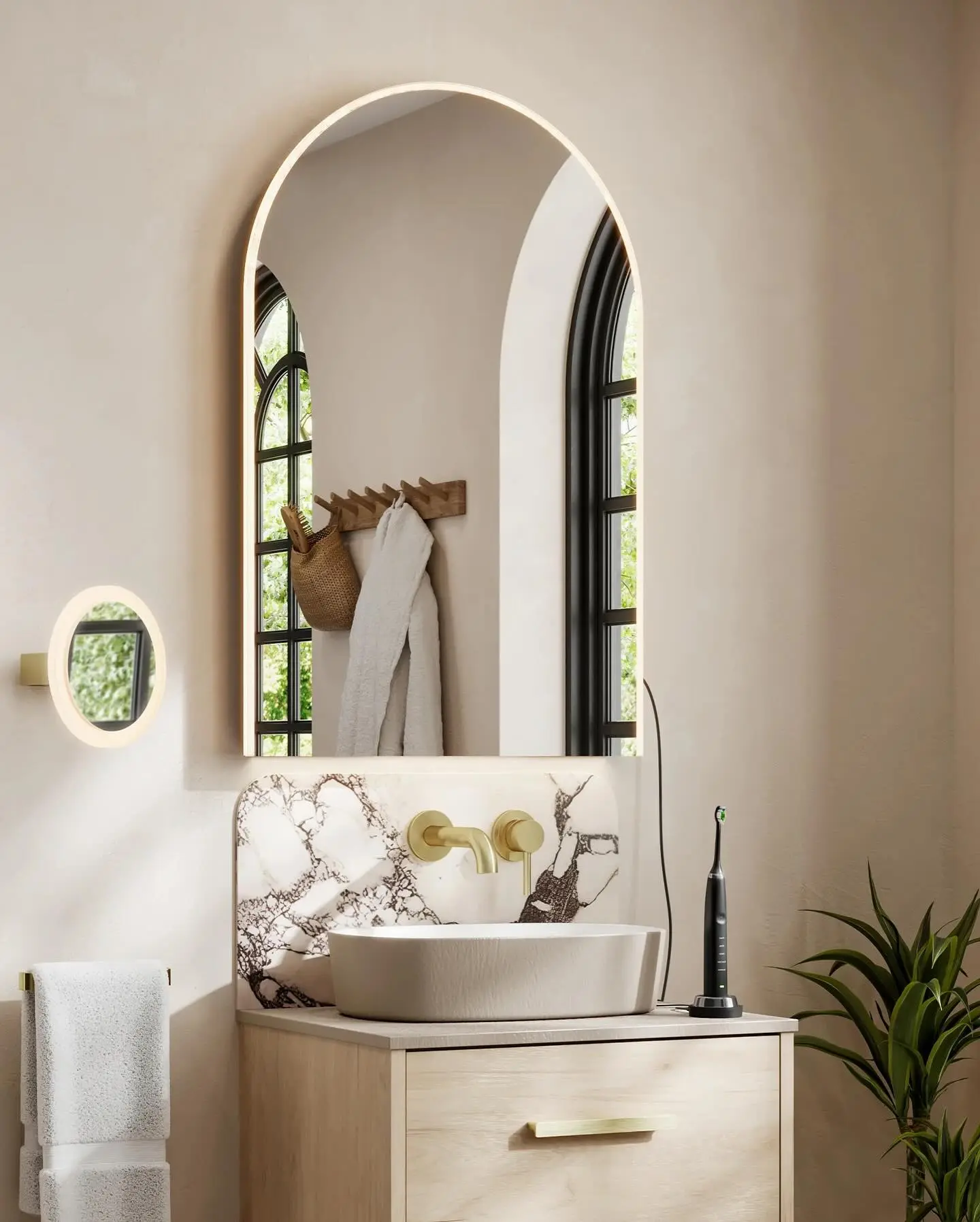 A modern bathroom with a backlit arched mirror over a light wood vanity and a white vessel sink.