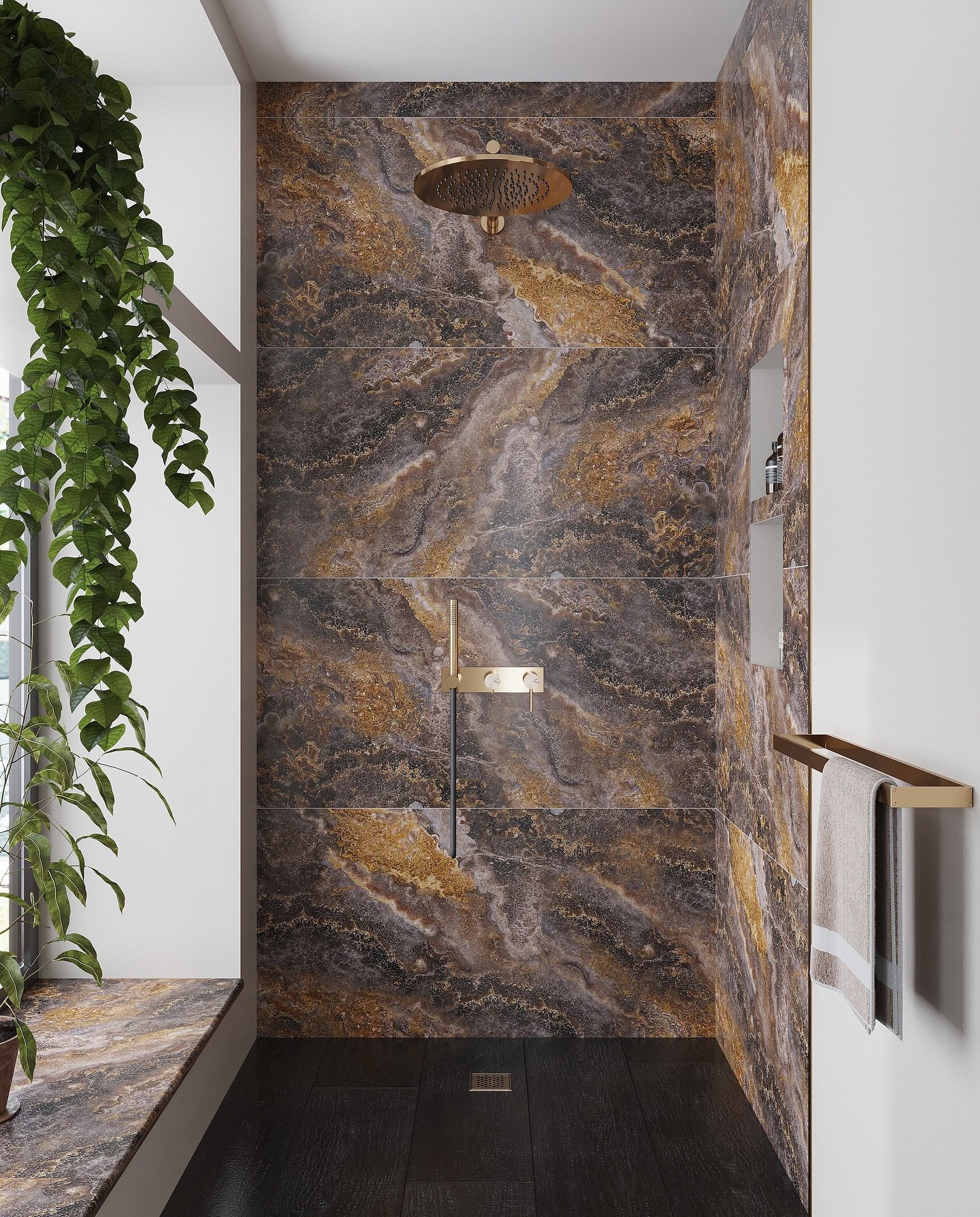 A luxurious walk-in shower with large-format black and gold-veined marble slab tiles, dark floor tiling, and brushed gold fixtures.