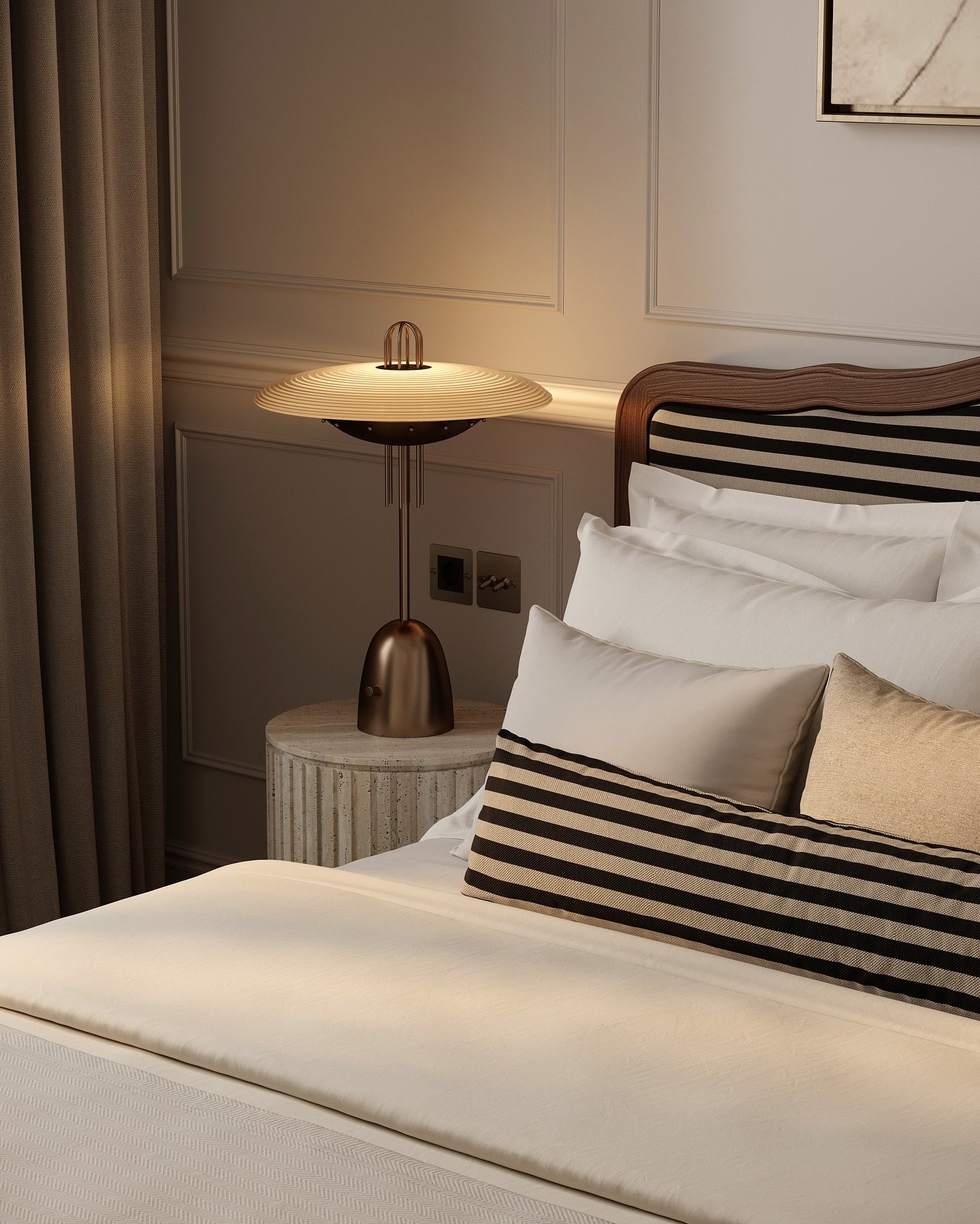 A unique, mid-century modern-style lamp with a fluted, saucer-like shade and a bronze base on a fluted bedside table.