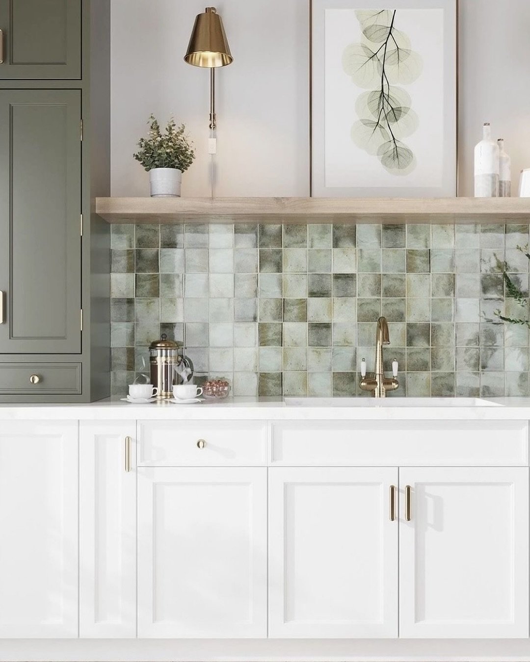 Kitchen backsplash featuring handcrafted-look square tiles in varied sage green and taupe tones with white cabinetry and brass hardware.
