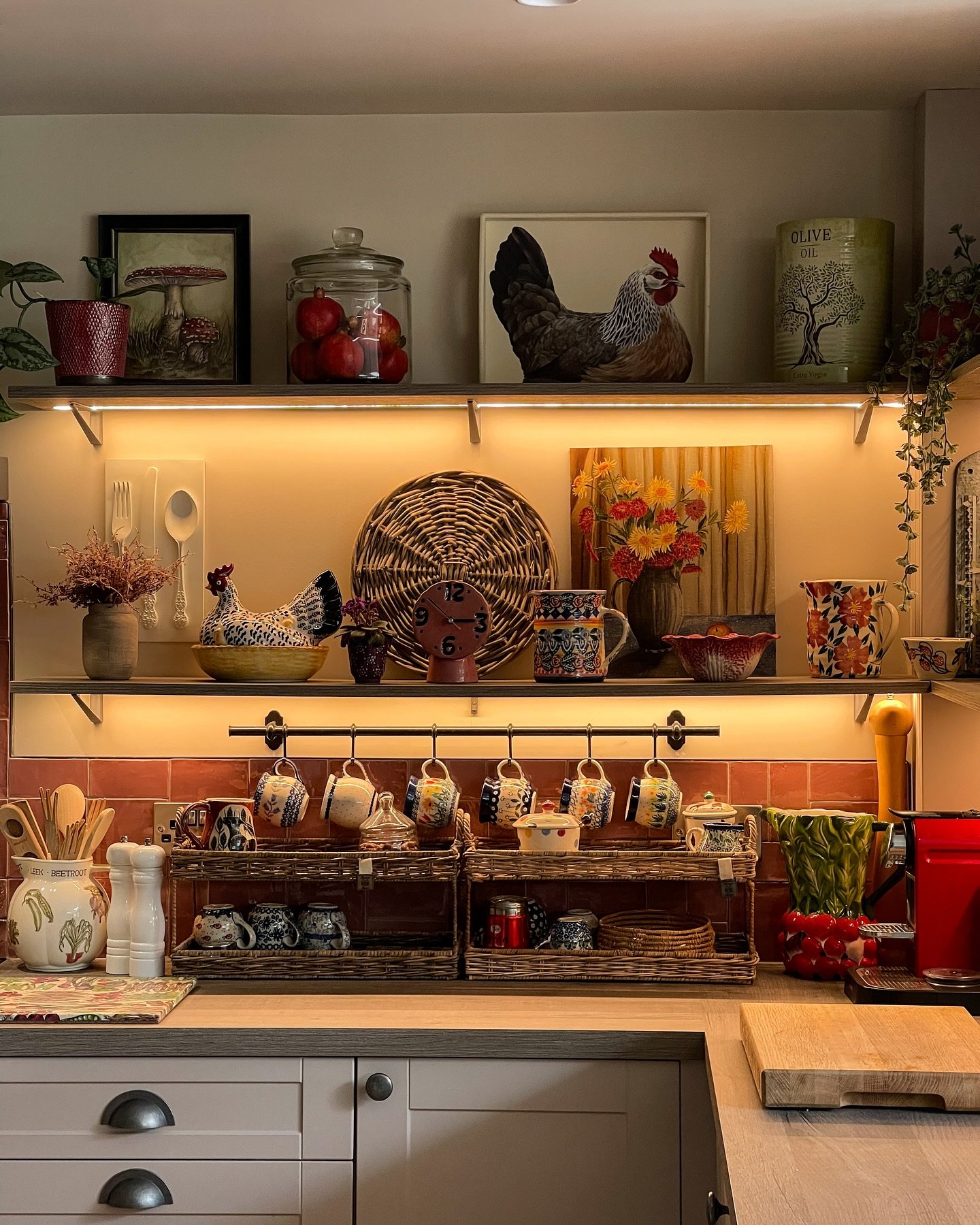 A medium-sized framed print, featuring a simple figure drawing, casually leaning against the wall on a kitchen counter.