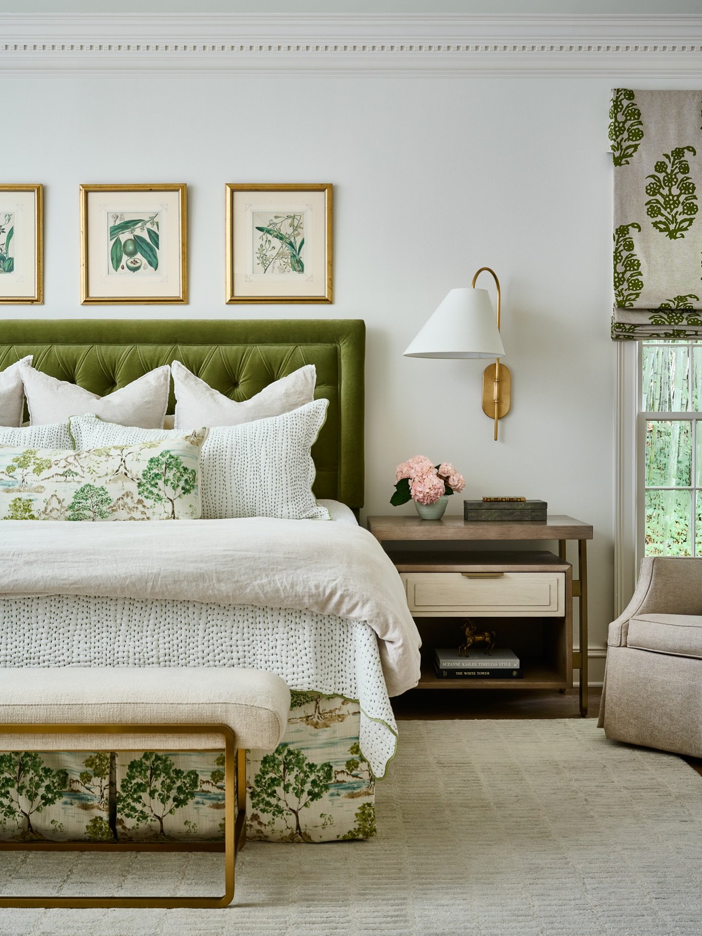 Elegant farmhouse bedroom with a bold olive green tufted headboard and custom bedding featuring a green and white tree print.