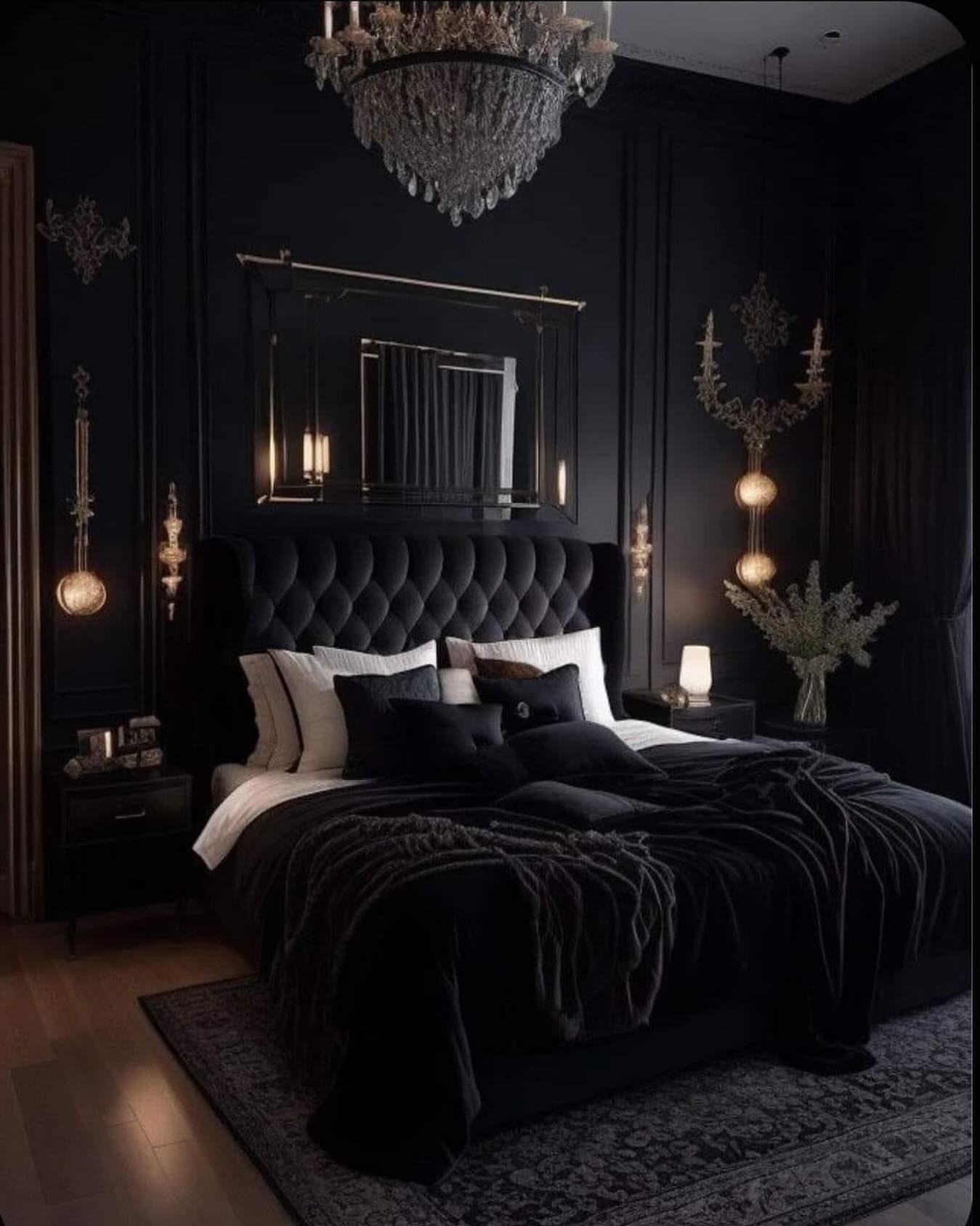 Extremely dark and luxurious bedroom with matte black walls, a dramatic tufted velvet headboard, a large crystal chandelier, and gold wall sconces.