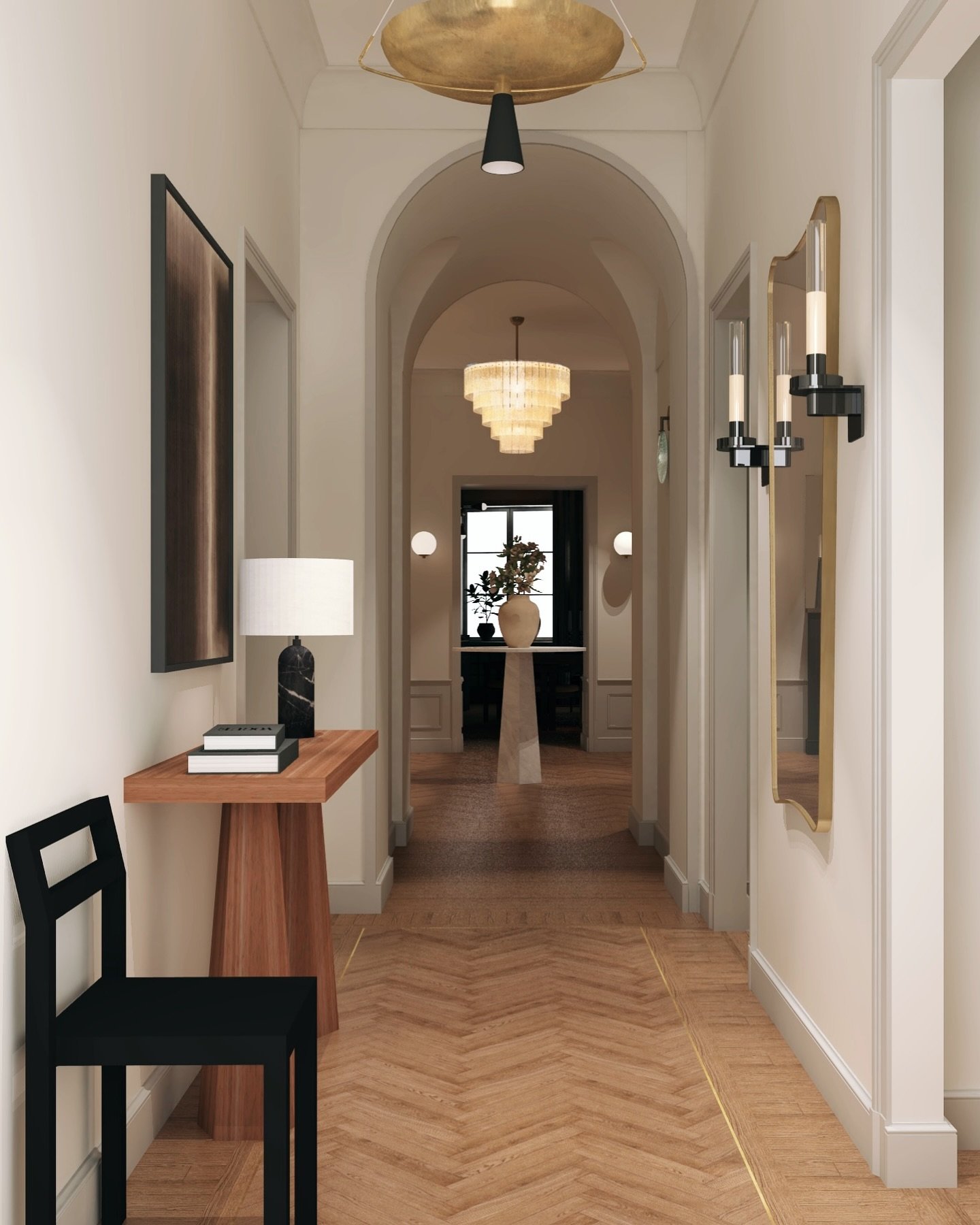 Modern hallway with chevron wood floors, a gold floor inlay, an arched ceiling opening, a black and brass saucer pendant, black wall sconces, and a tiered chandelier visible in the distance