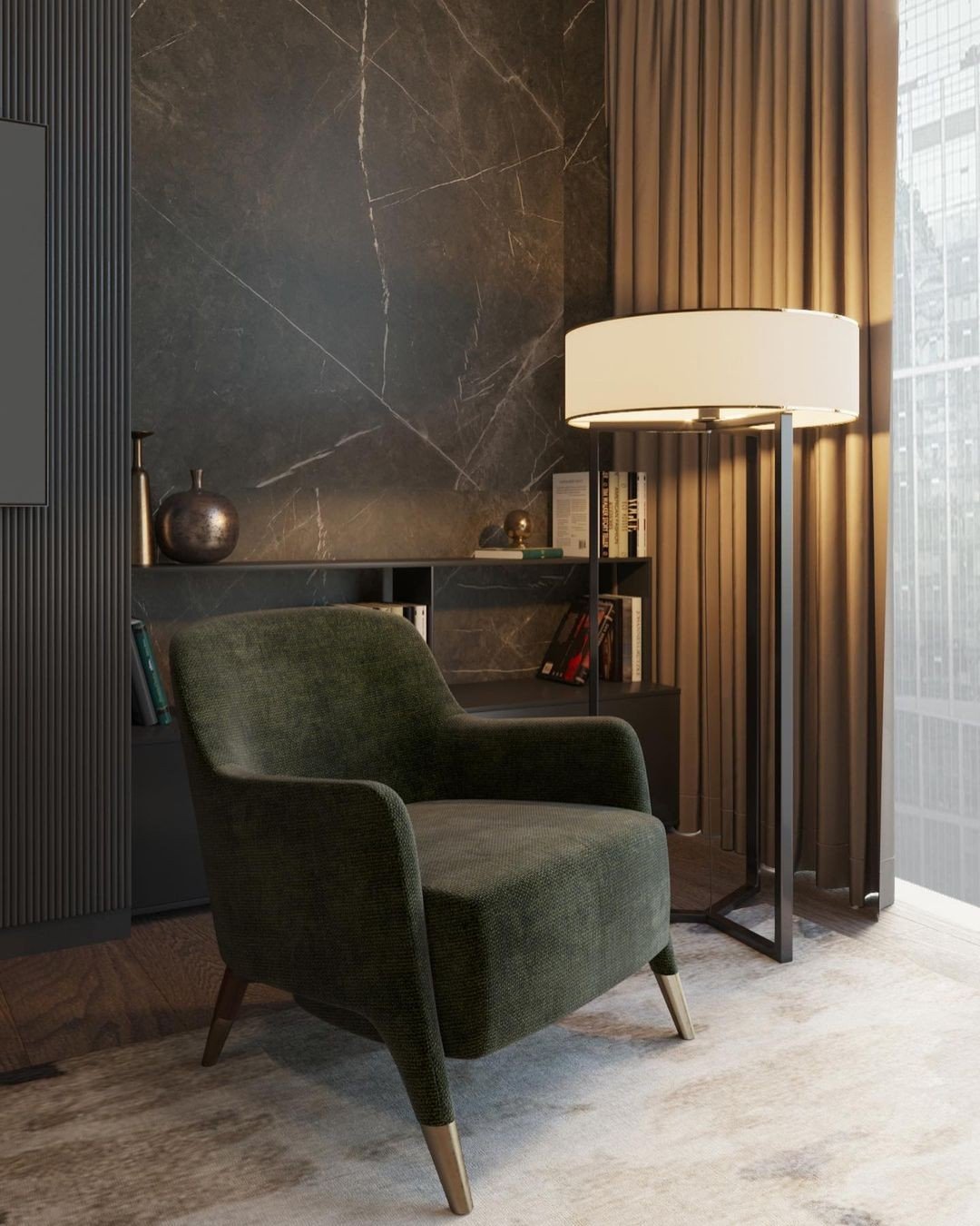 Luxury modern reading corner with a dark green velvet armchair, a black marble feature wall, and a large contemporary floor lamp with a drum shade.
