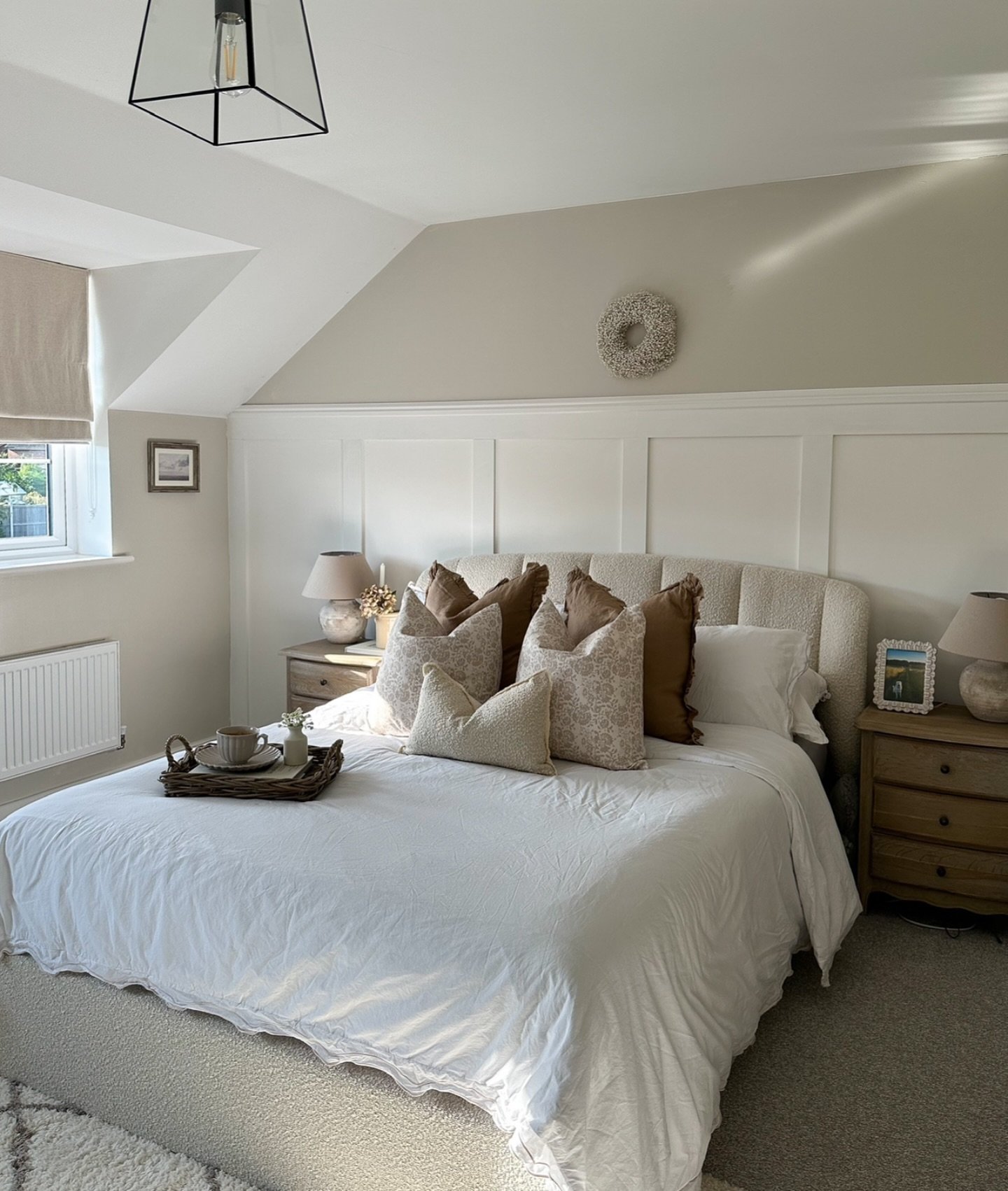 Neutral farmhouse bedroom with vertical panel wall trim, a cozy teddy fabric bed, and light wood nightstands.