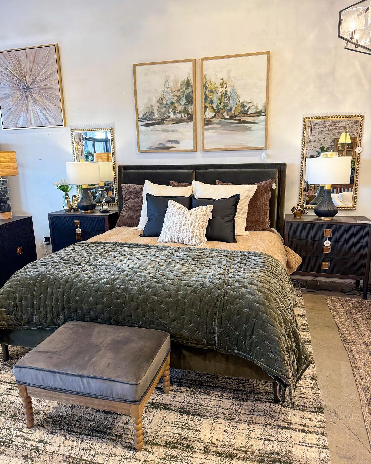 A sophisticated bedroom featuring a dark olive green velvet quilt, matching bed frame, and black nightstands.