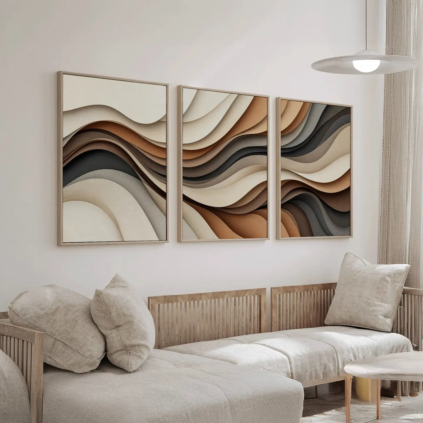 Three-panel triptych wall art with abstract waves in layers of brown, beige, and black, framed in wood and hung above a light linen sofa.